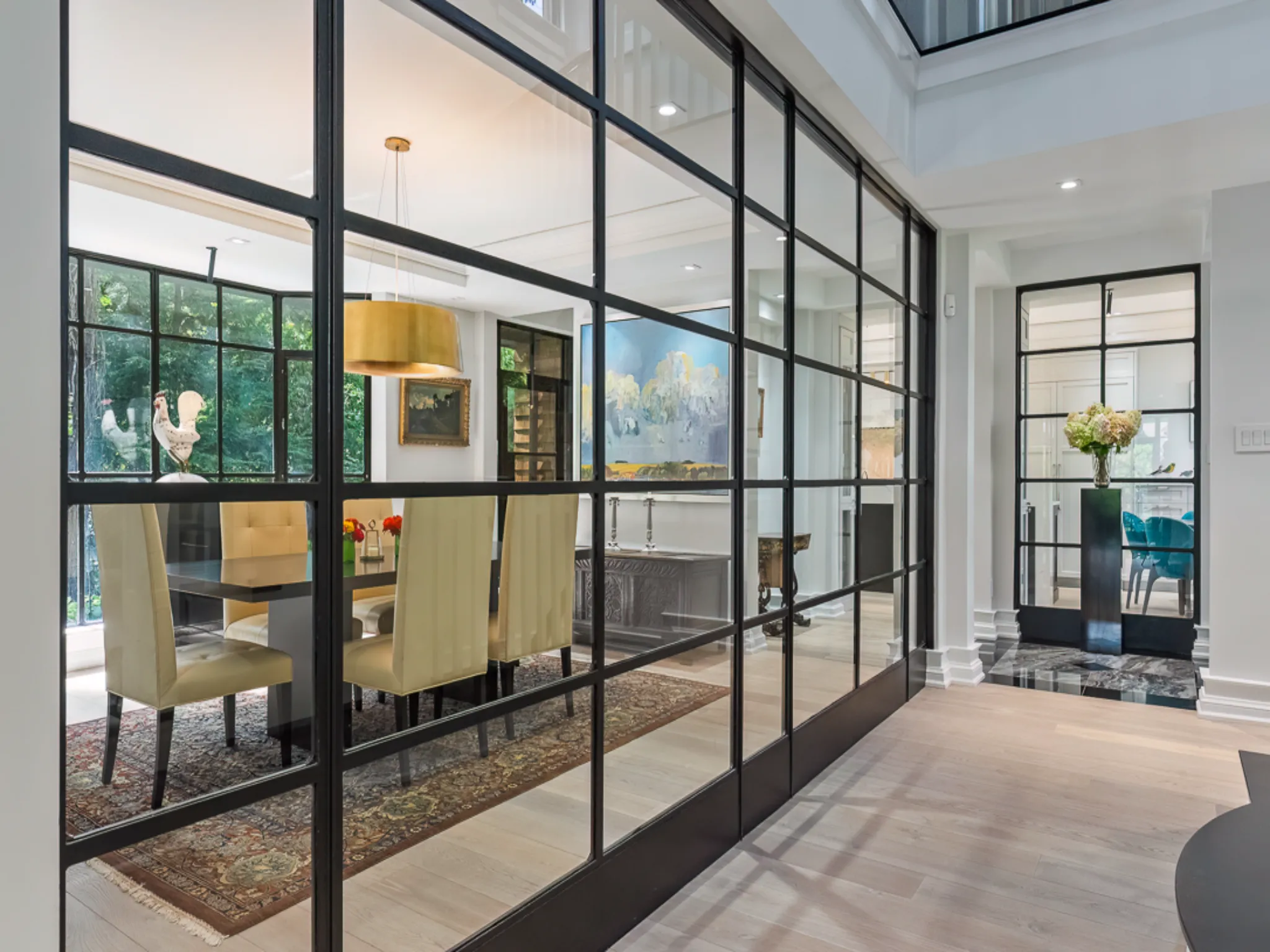 Modern dining area with glass walls and stylish decor