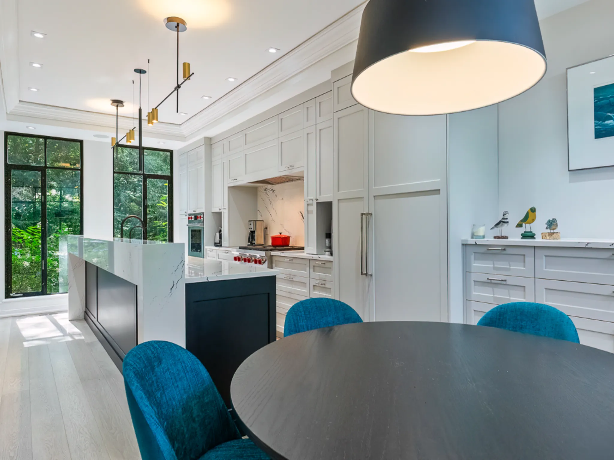 Modern kitchen with white cabinetry and a round dining table