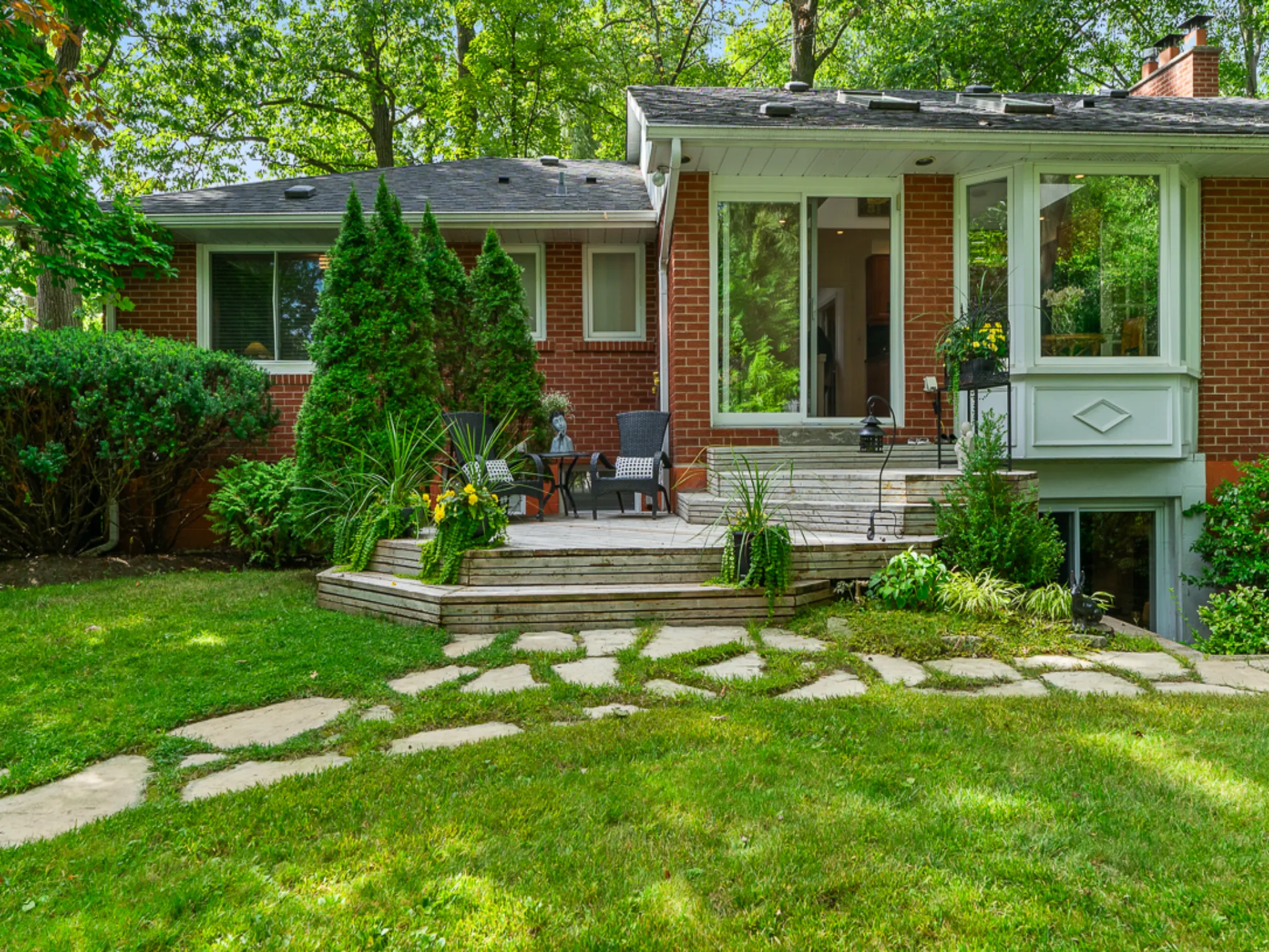 back of the house showing grassy path and deck