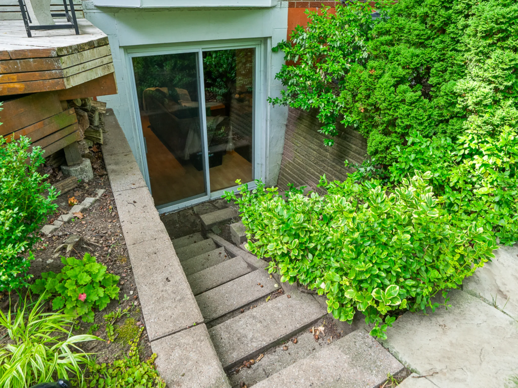 concrete stairs leading down to basement door