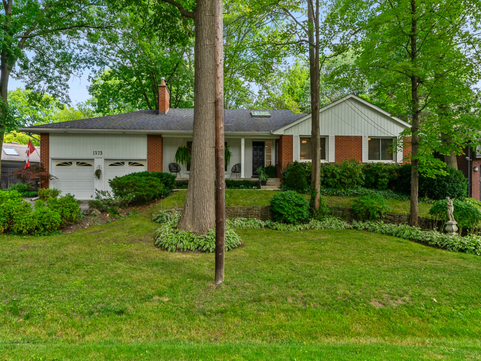 exterior front of home with yard and mature trees