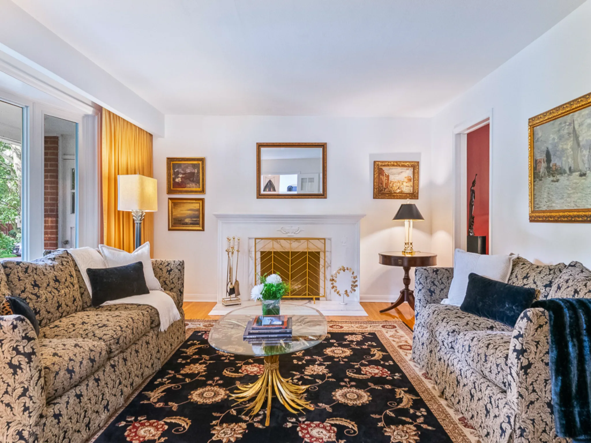 living room with large bay window and fireplace