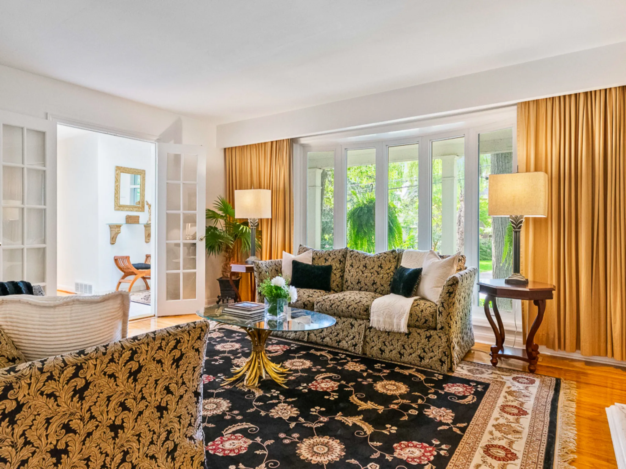 living room with large bay window and french doors