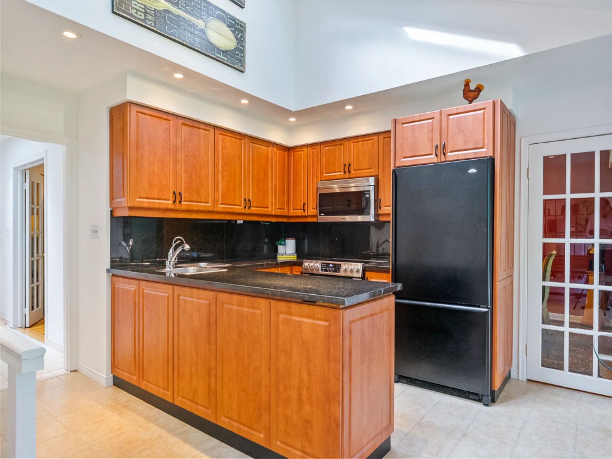 kitchen with pot lights and wood colour cabinets