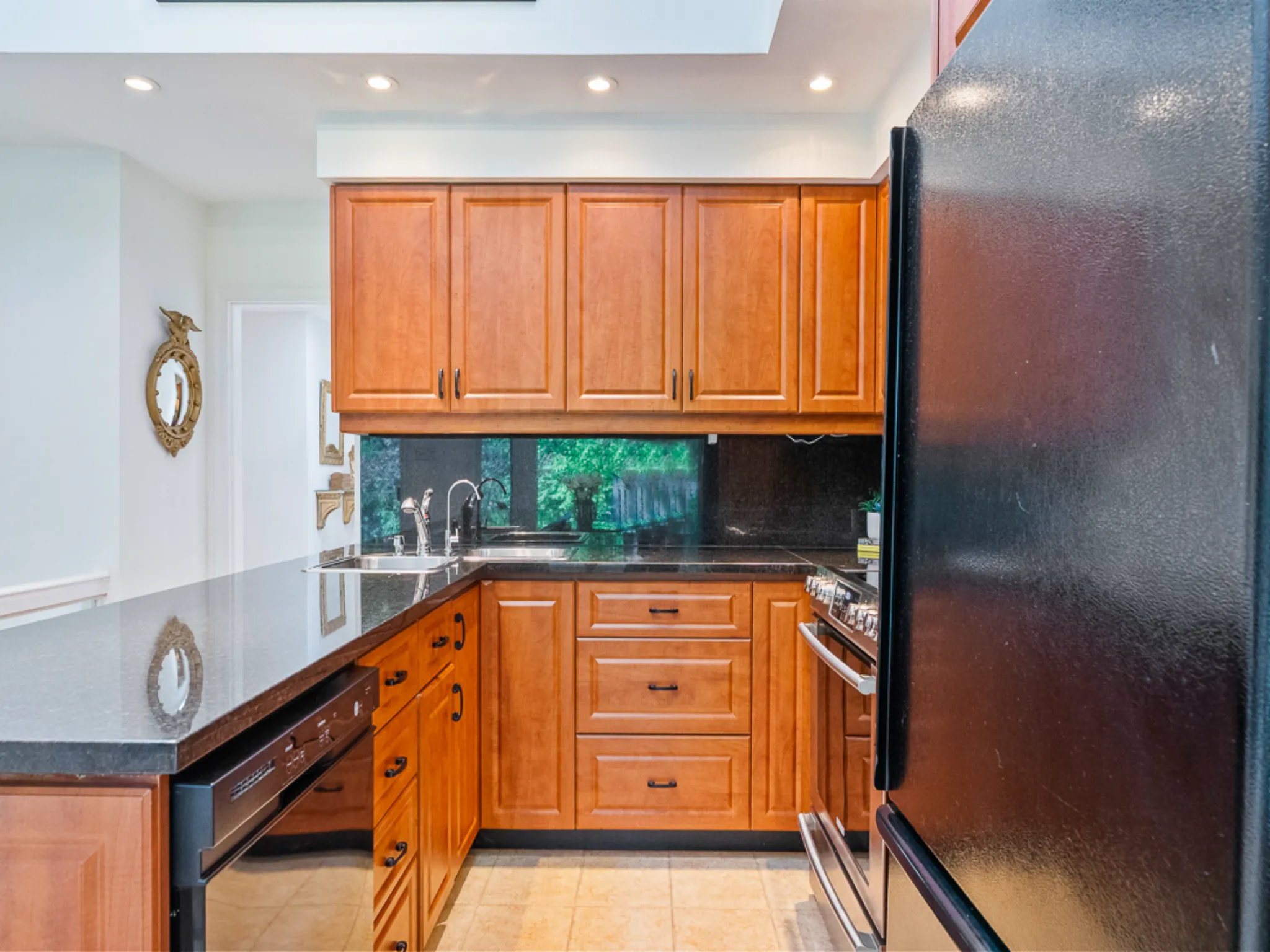 stone counters with wood colour cabinets in kitchen
