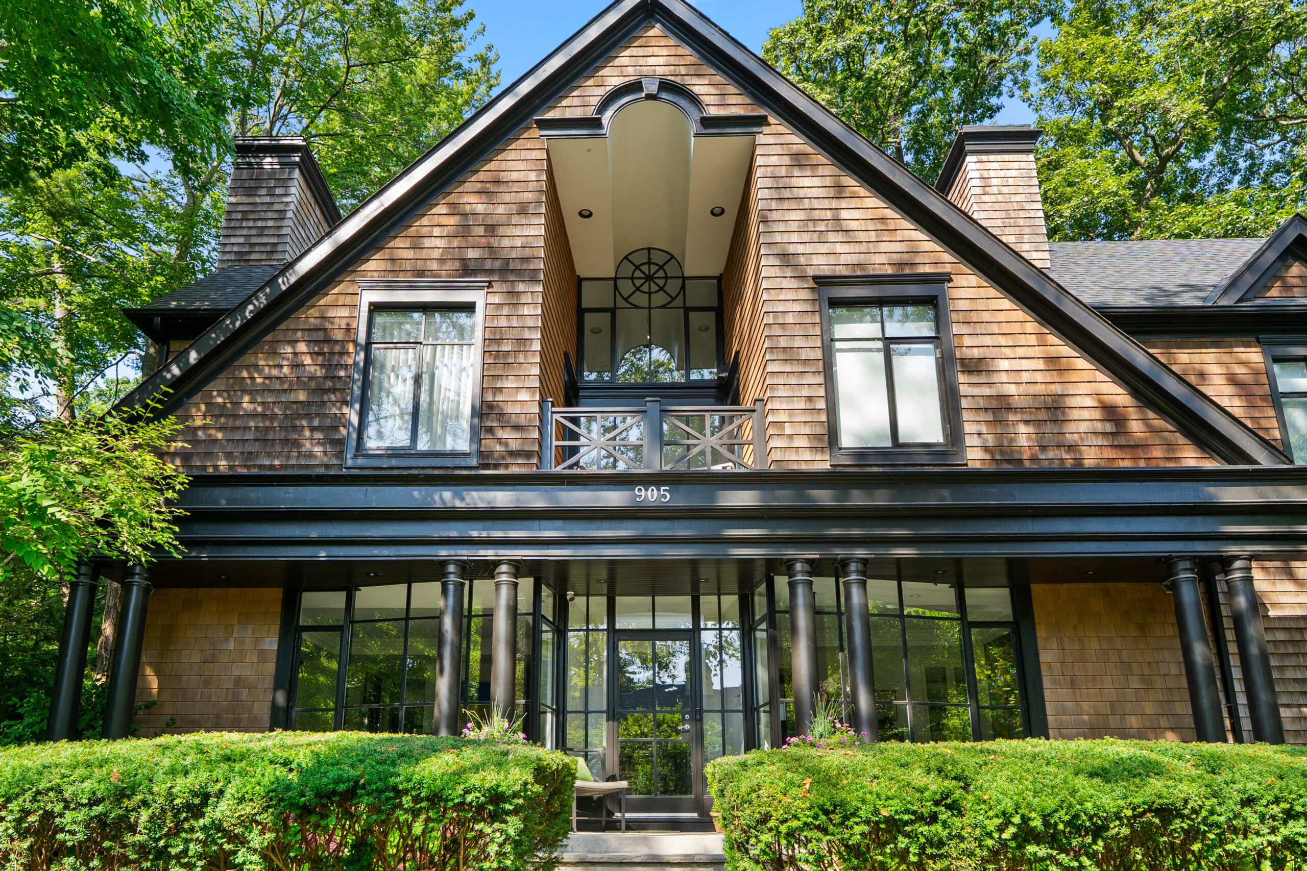 Elegant two-story house with a gabled roof and large windows