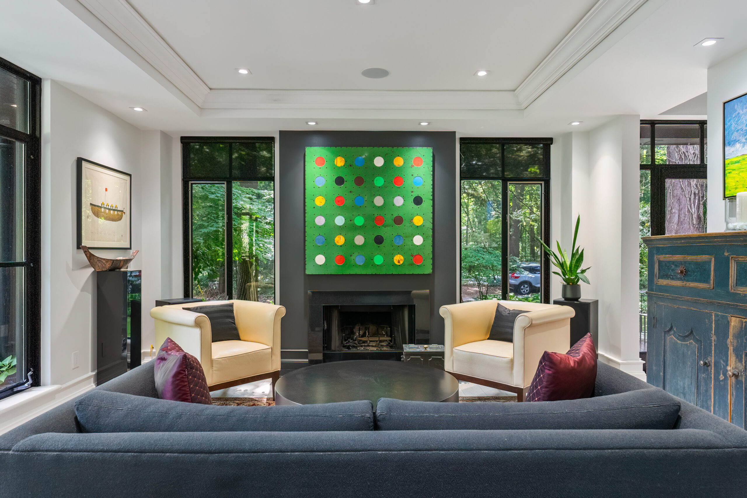 Modern living room with a colorful wall art and cozy seating.