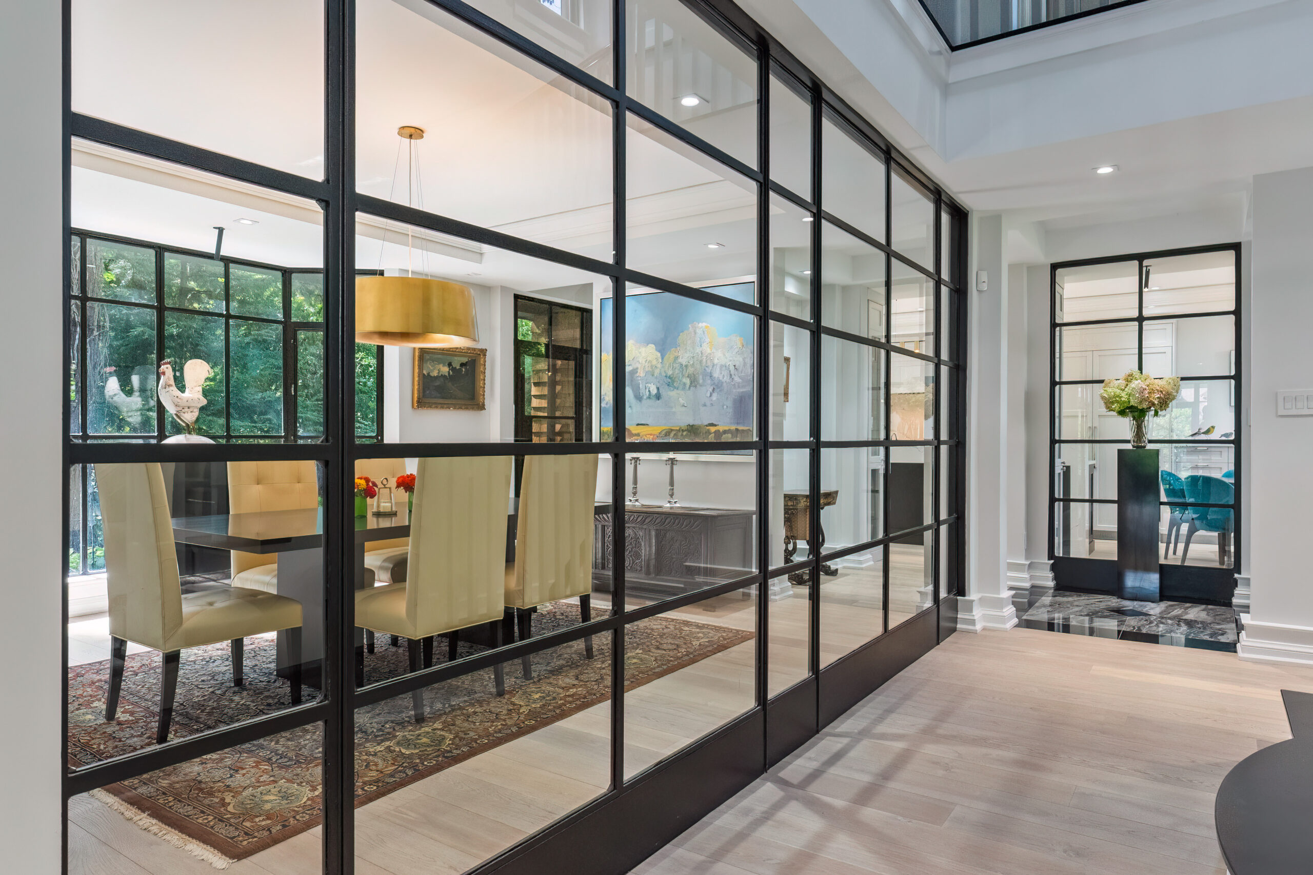 Modern dining area with glass walls and stylish decor