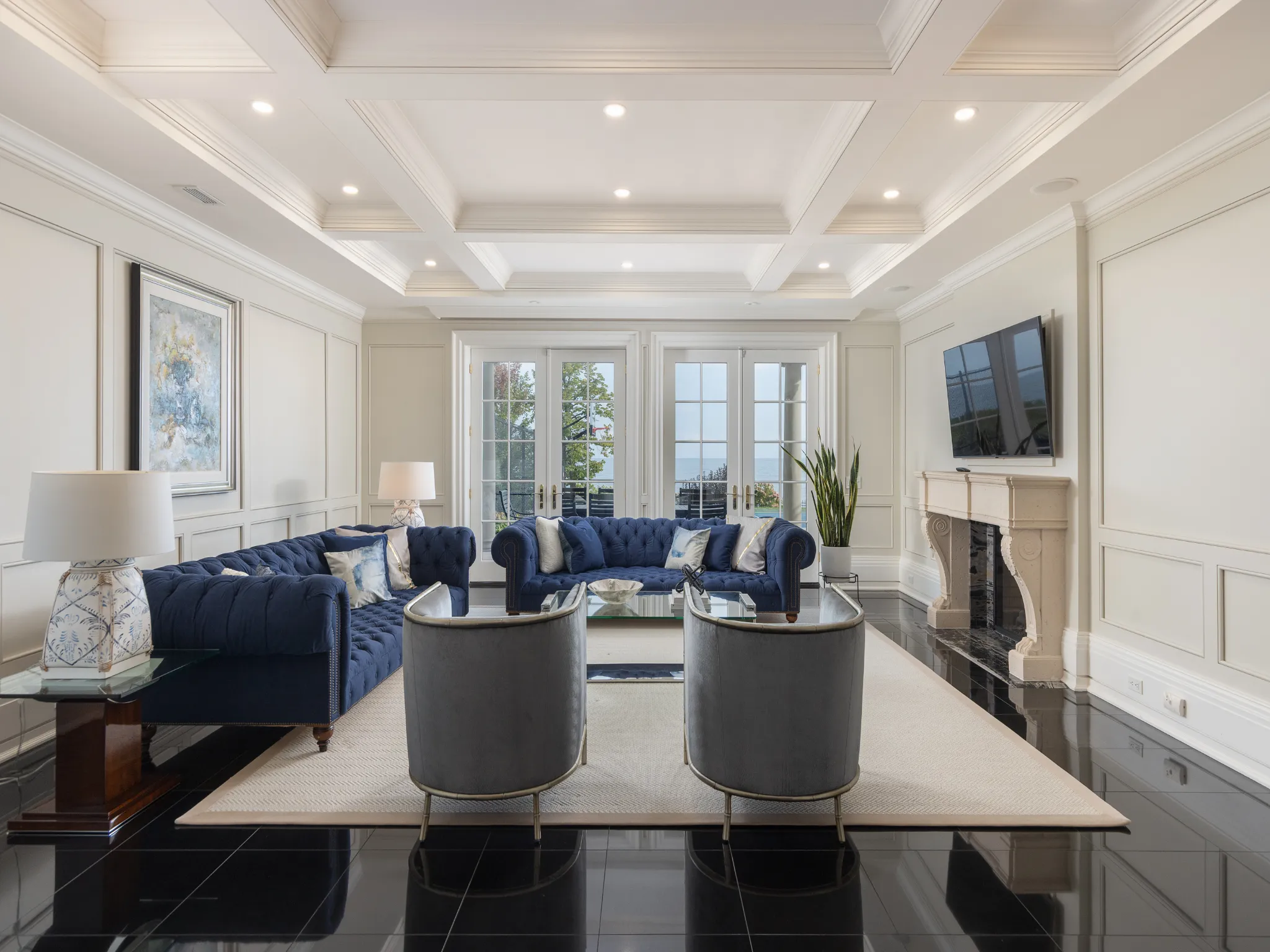 living area featuring a fireplace, coffered ceiling, and recessed lighting