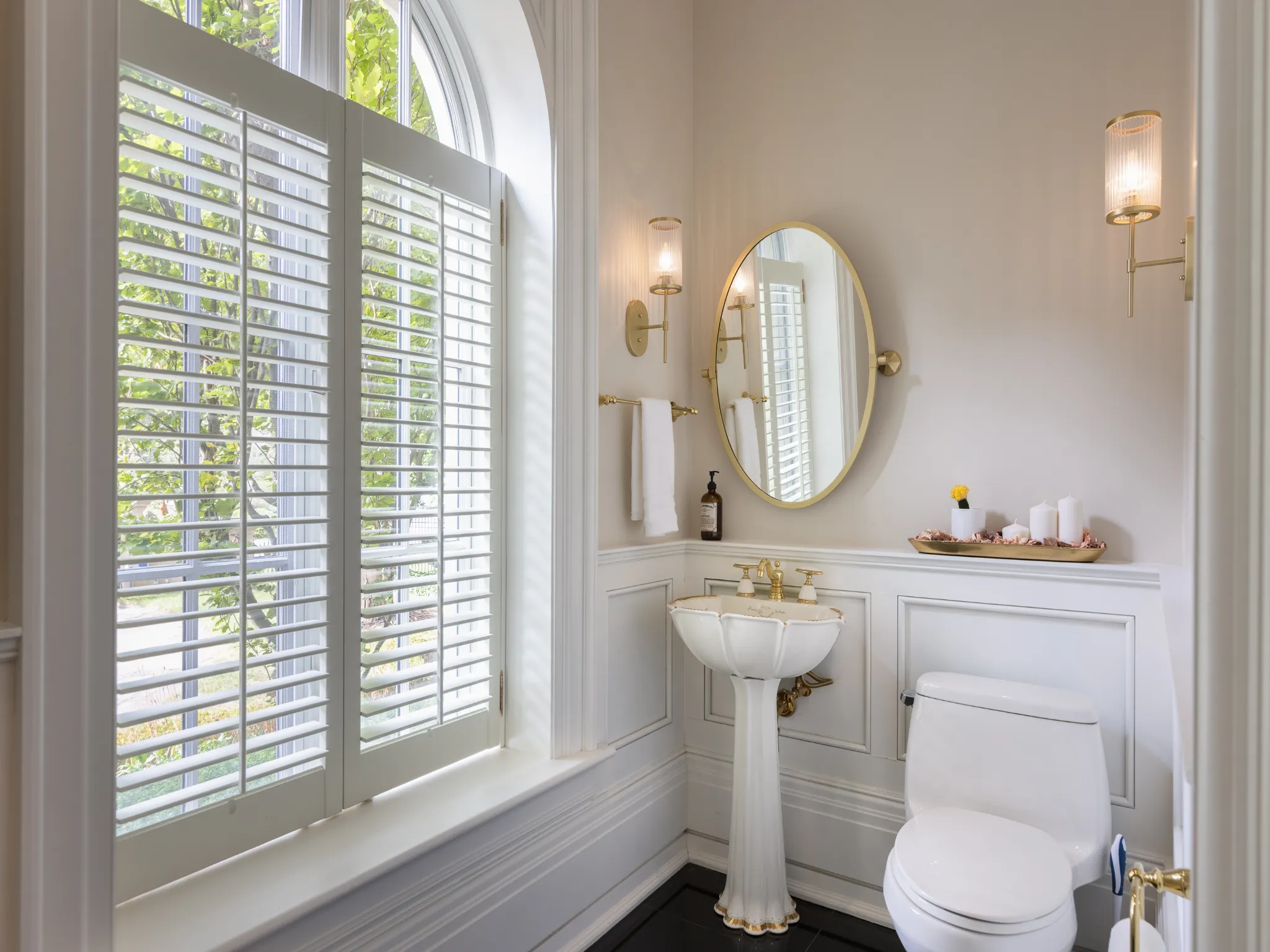 powder room with wainscoted wall and decorative wall