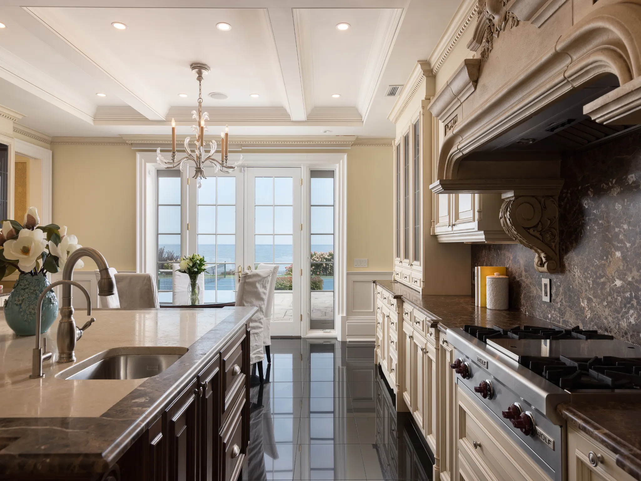 kitchen featuring glass insert cabinets, dark stone countertops, pendant lighting