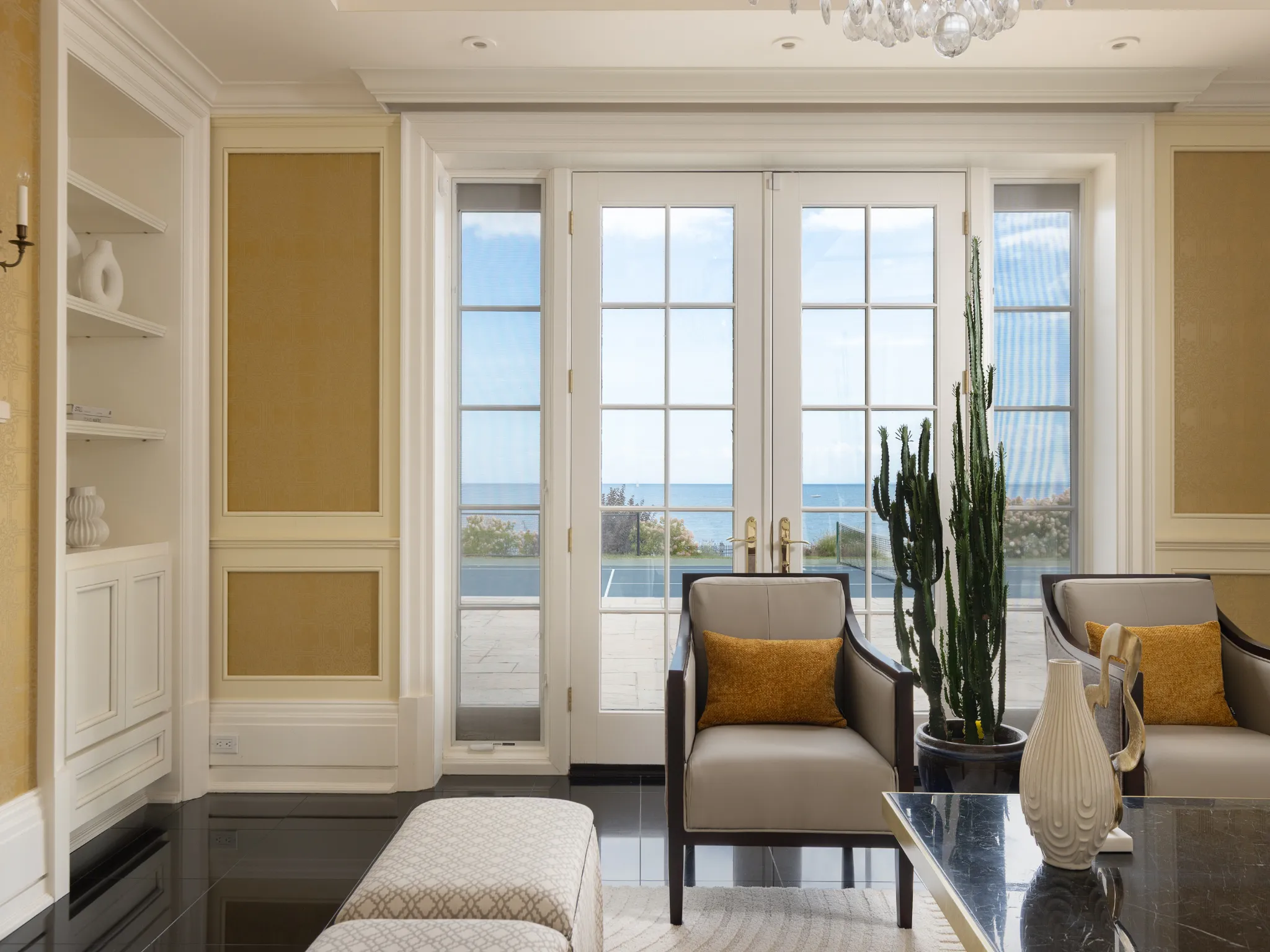 living room with chairs and cactus, overlooking the lake