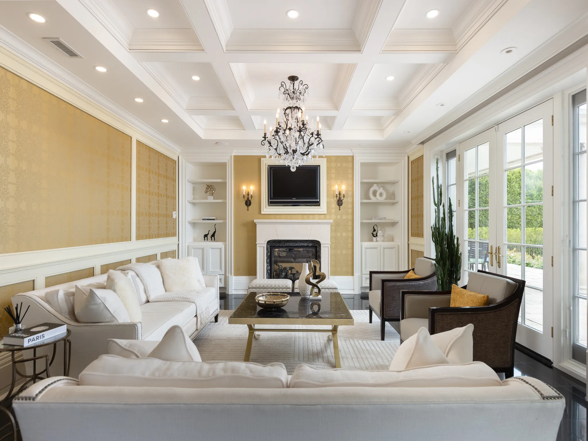 living room with coffered ceiling and fireplace with white couches