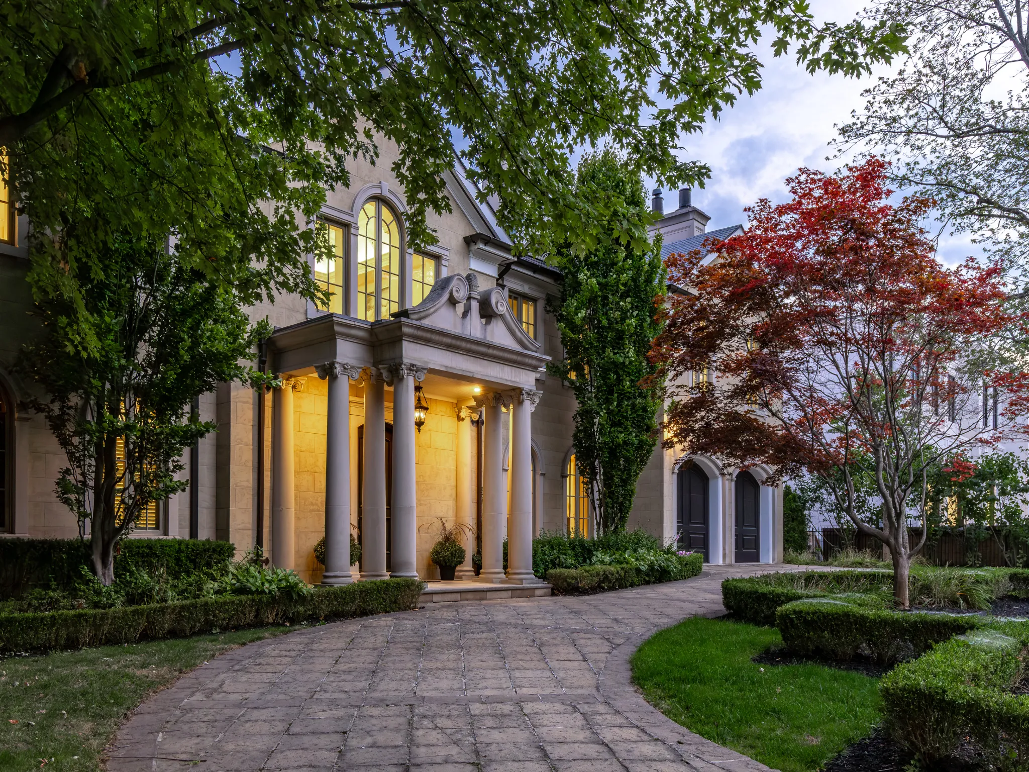 exterior of home showing drive way and gardens