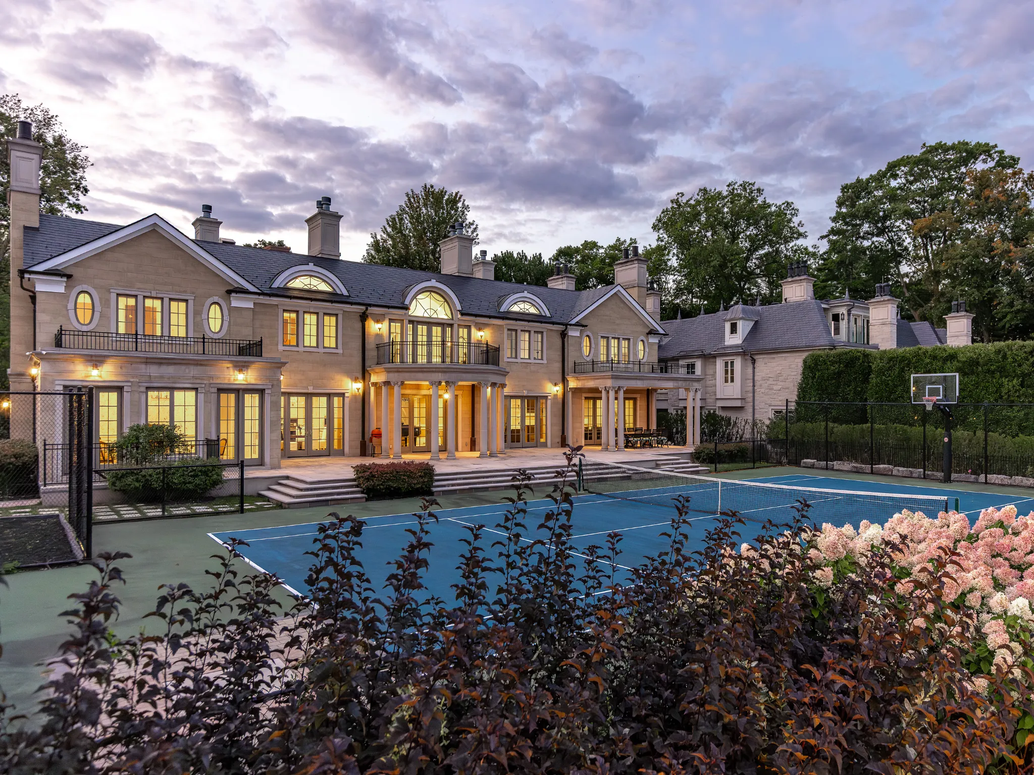 exterior photo at night time showing tennis court