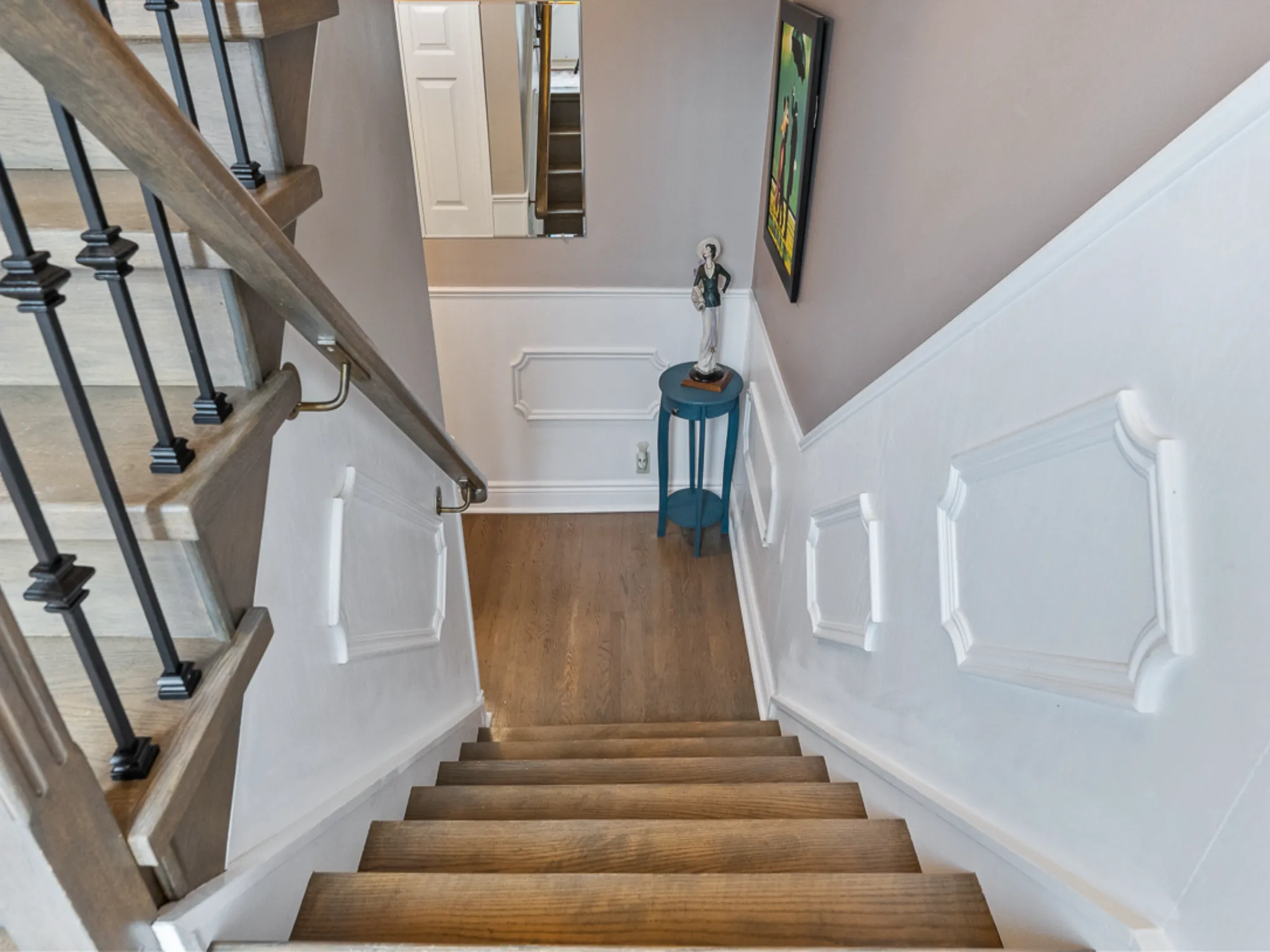 stairway down to the lower level, nice wainscoting on the walls