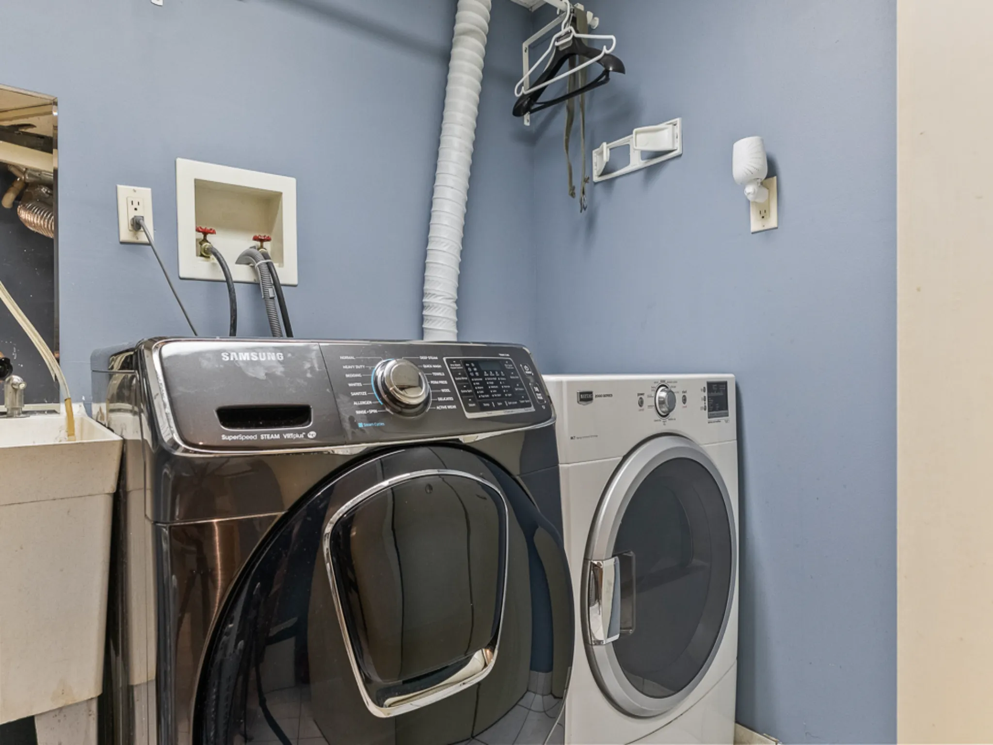 lower level laundry room with front load washer and dryer