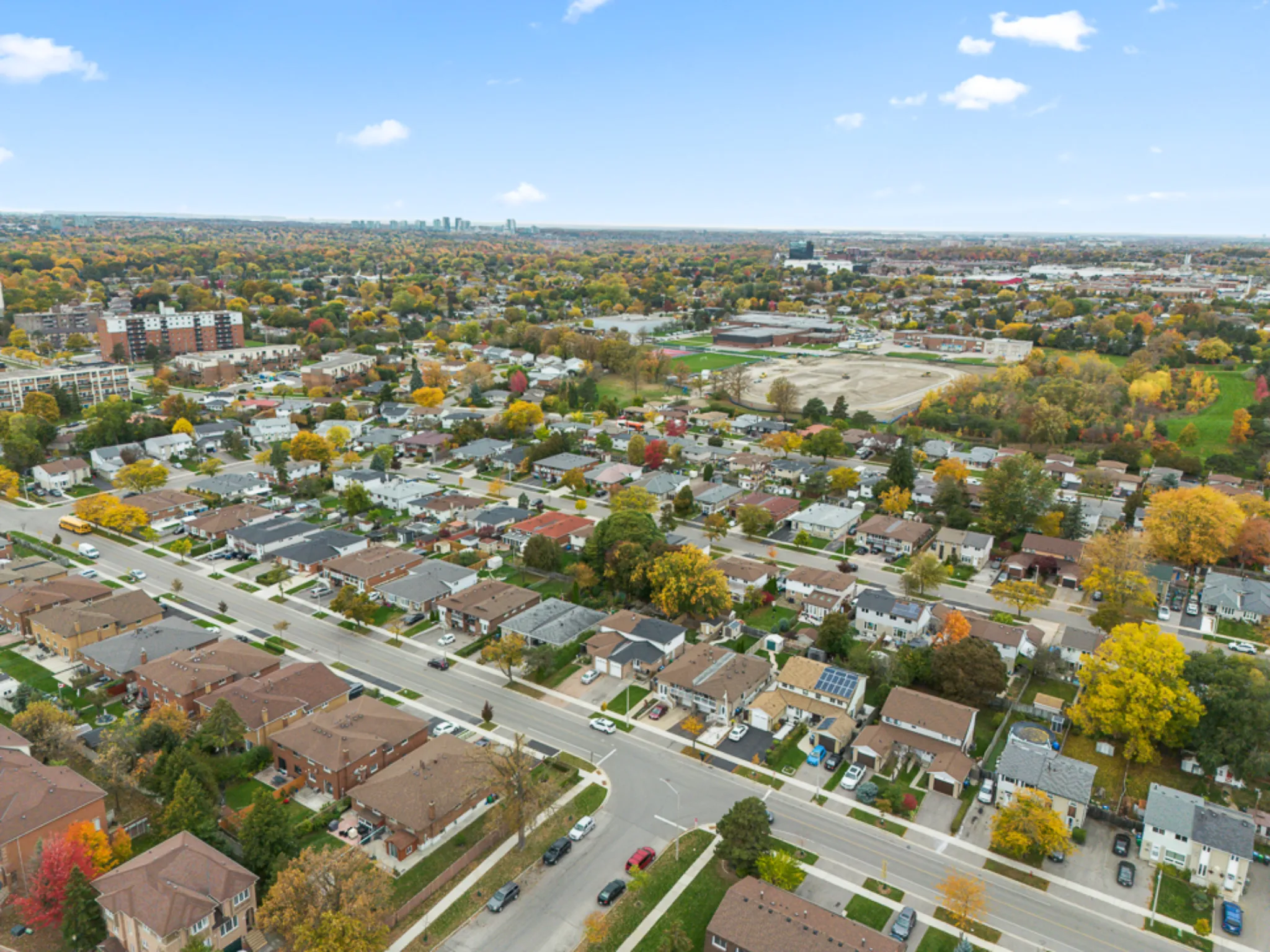 aerial view of the neighborhood showing many homes and tree tops