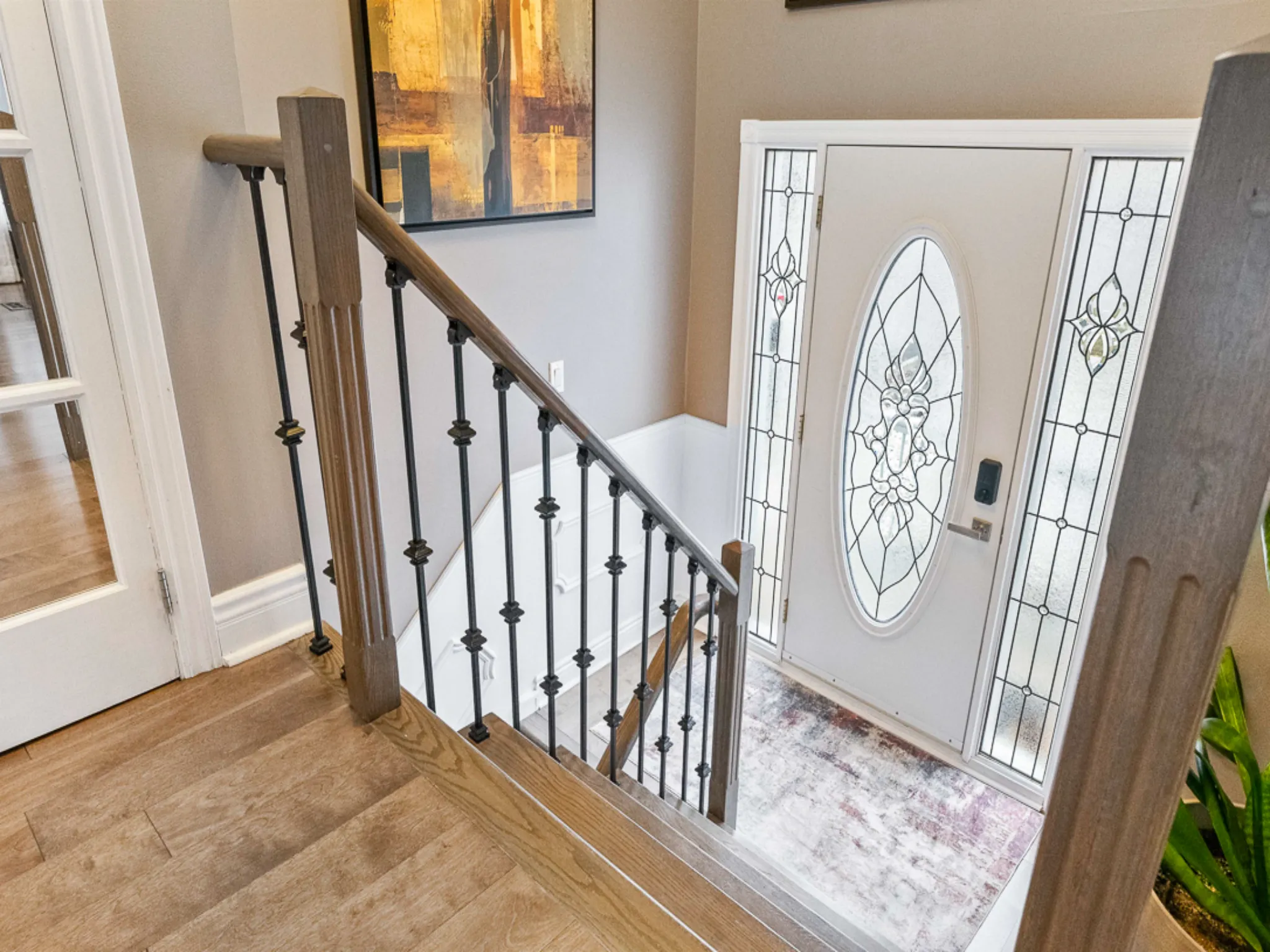 front foyer with white and glass front door and beige walls
