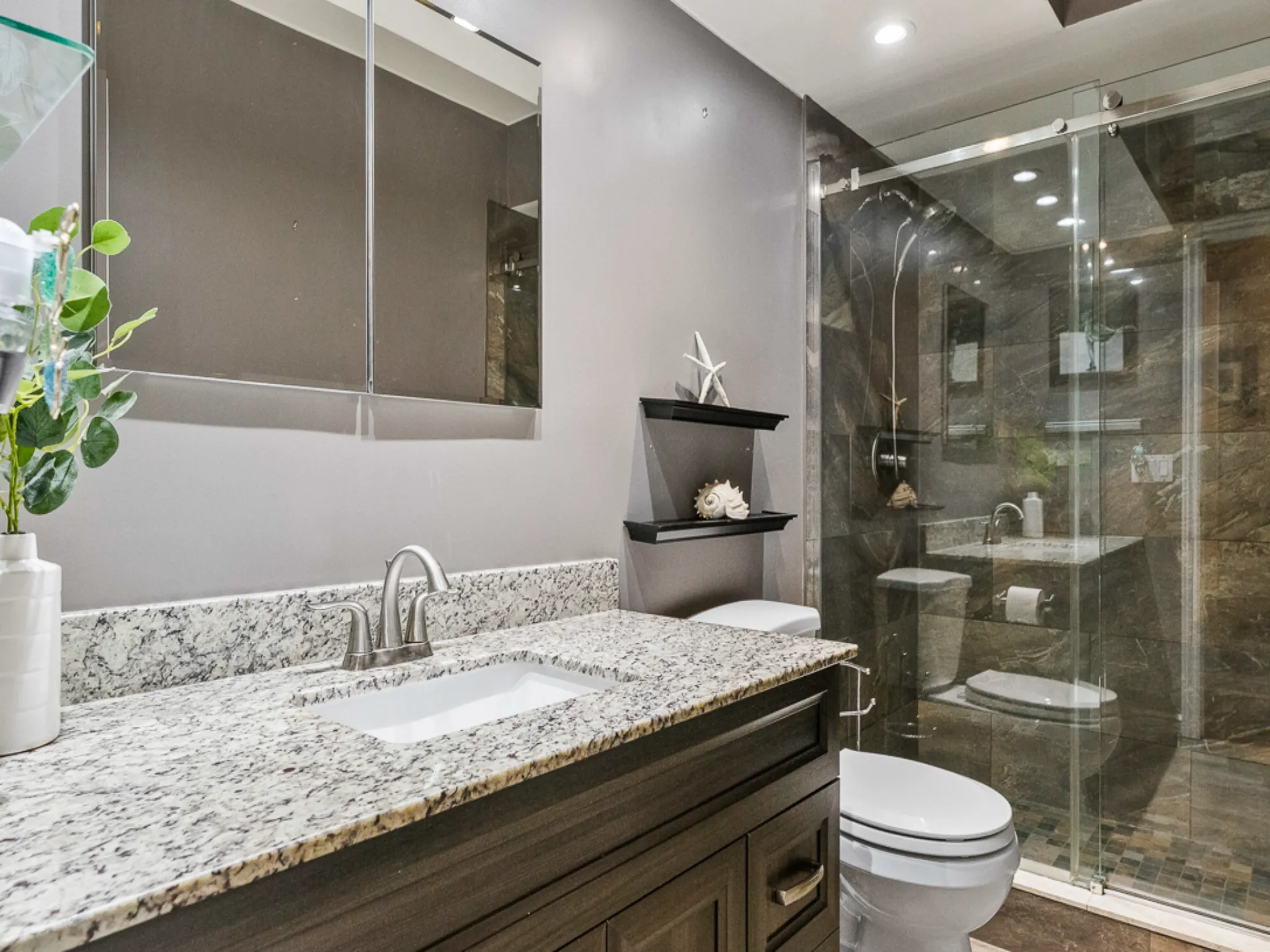 tastefully updated bathroom with vanity and glassed in shower