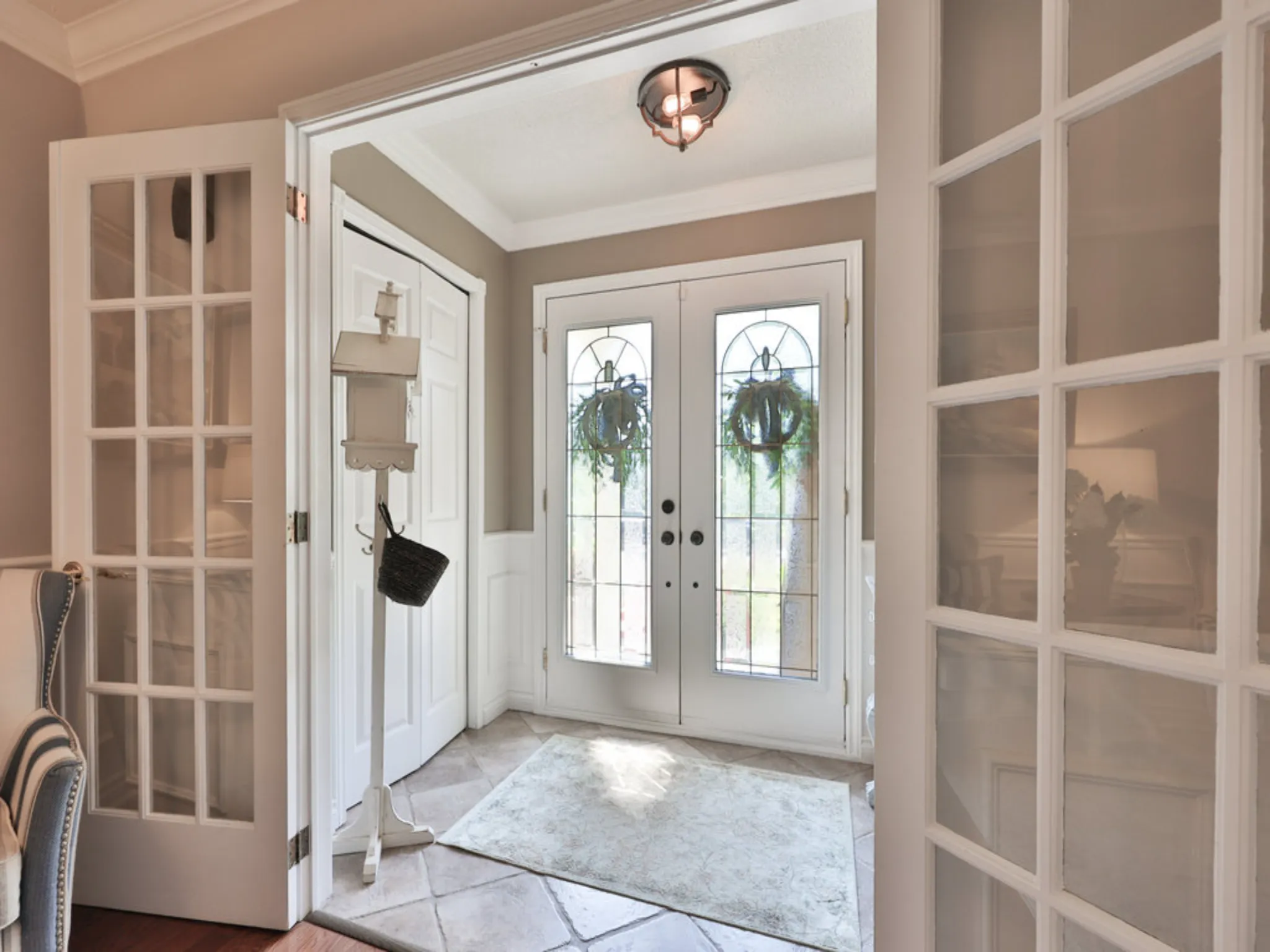 front foyer of the home with french doors and lots of light
