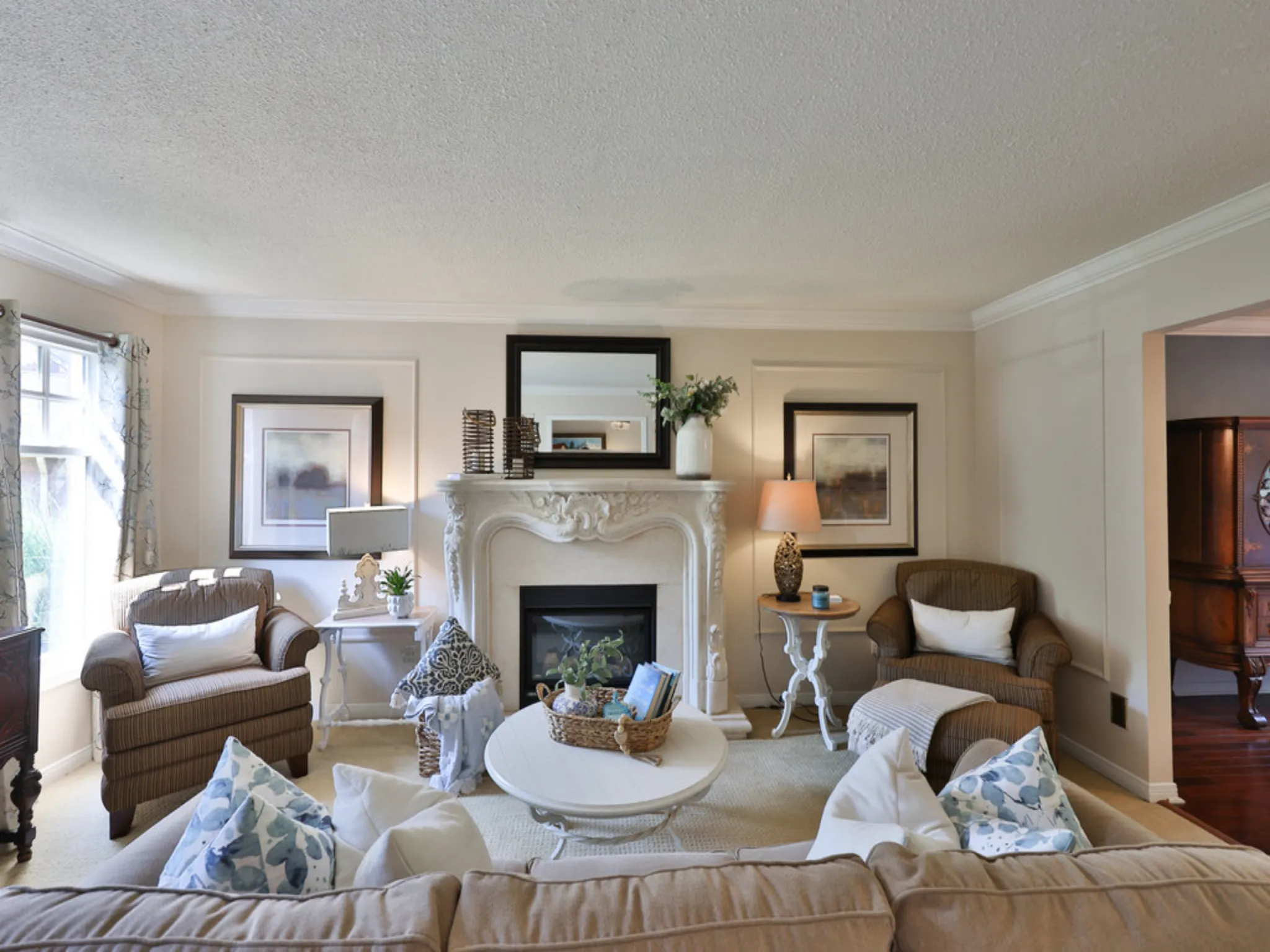 living room with lots of seating and ornate fireplace
