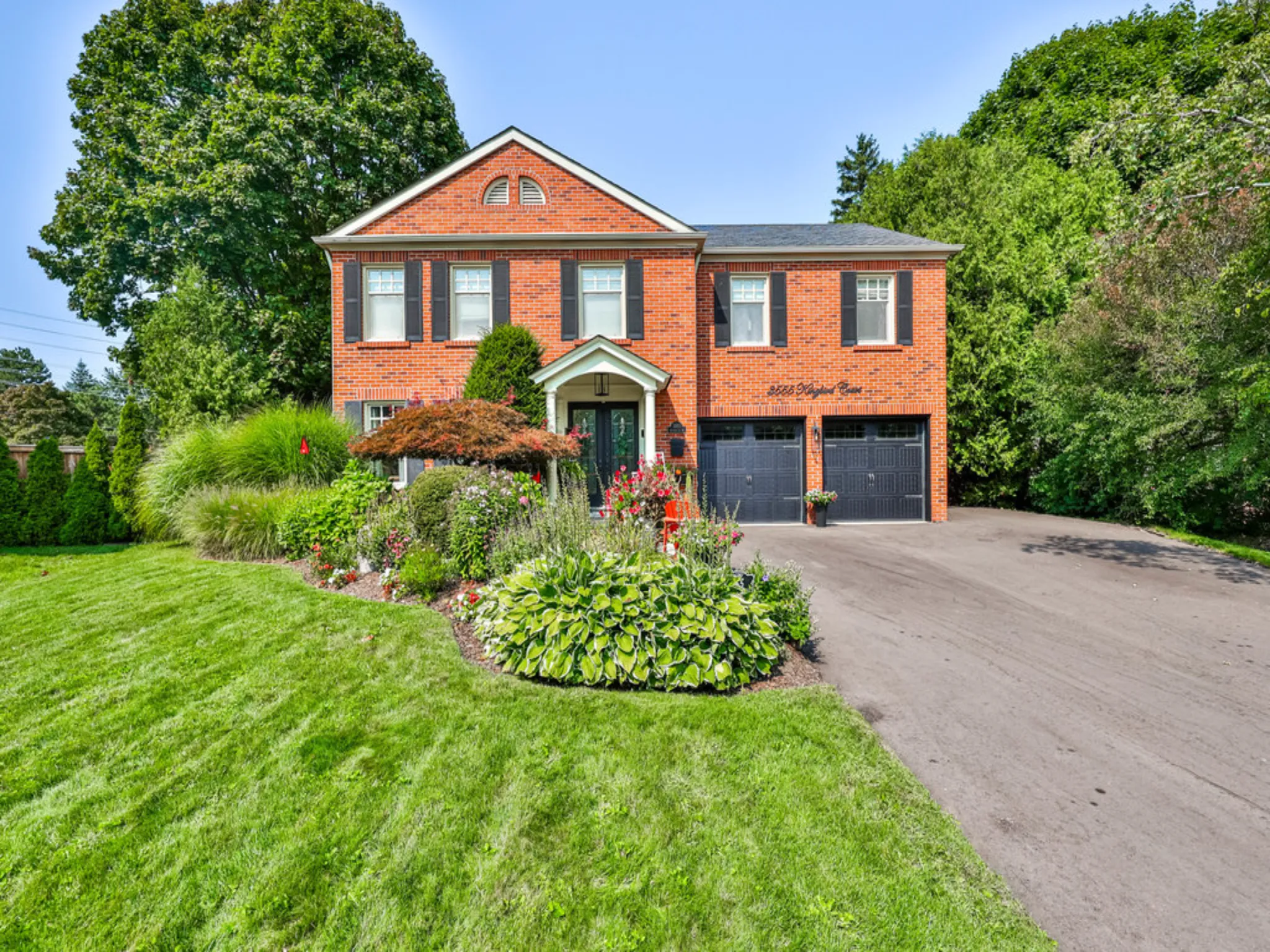 exterior of a brick home with double car garage and large driveway