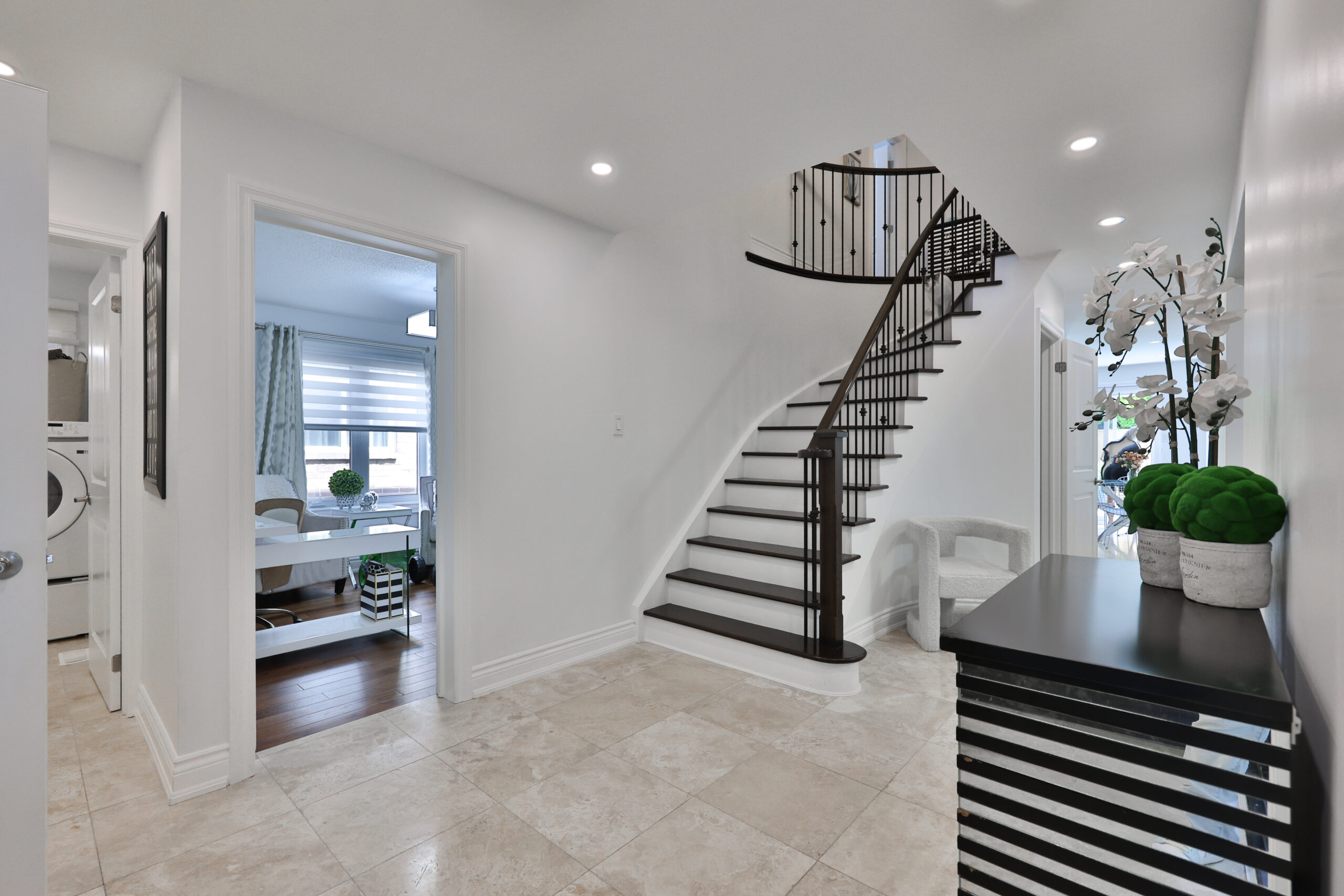 Bright entryway with a spiral staircase and modern decor