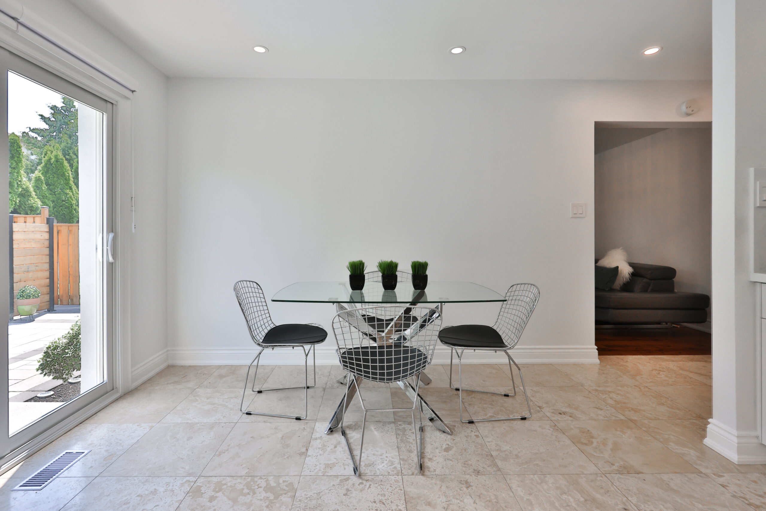 Modern dining area with a glass table and four chairs