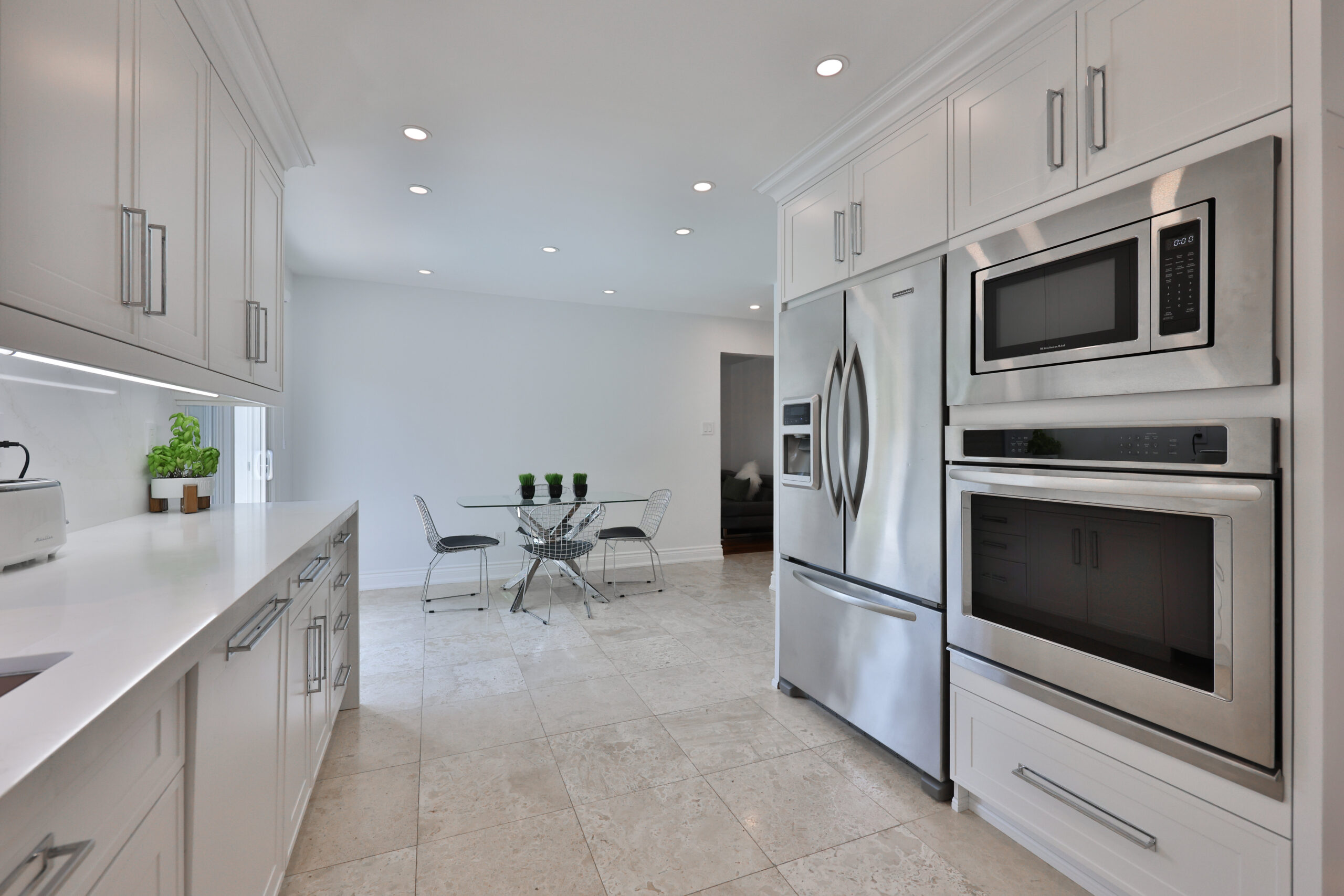 Modern kitchen with stainless steel appliances and a small dining table