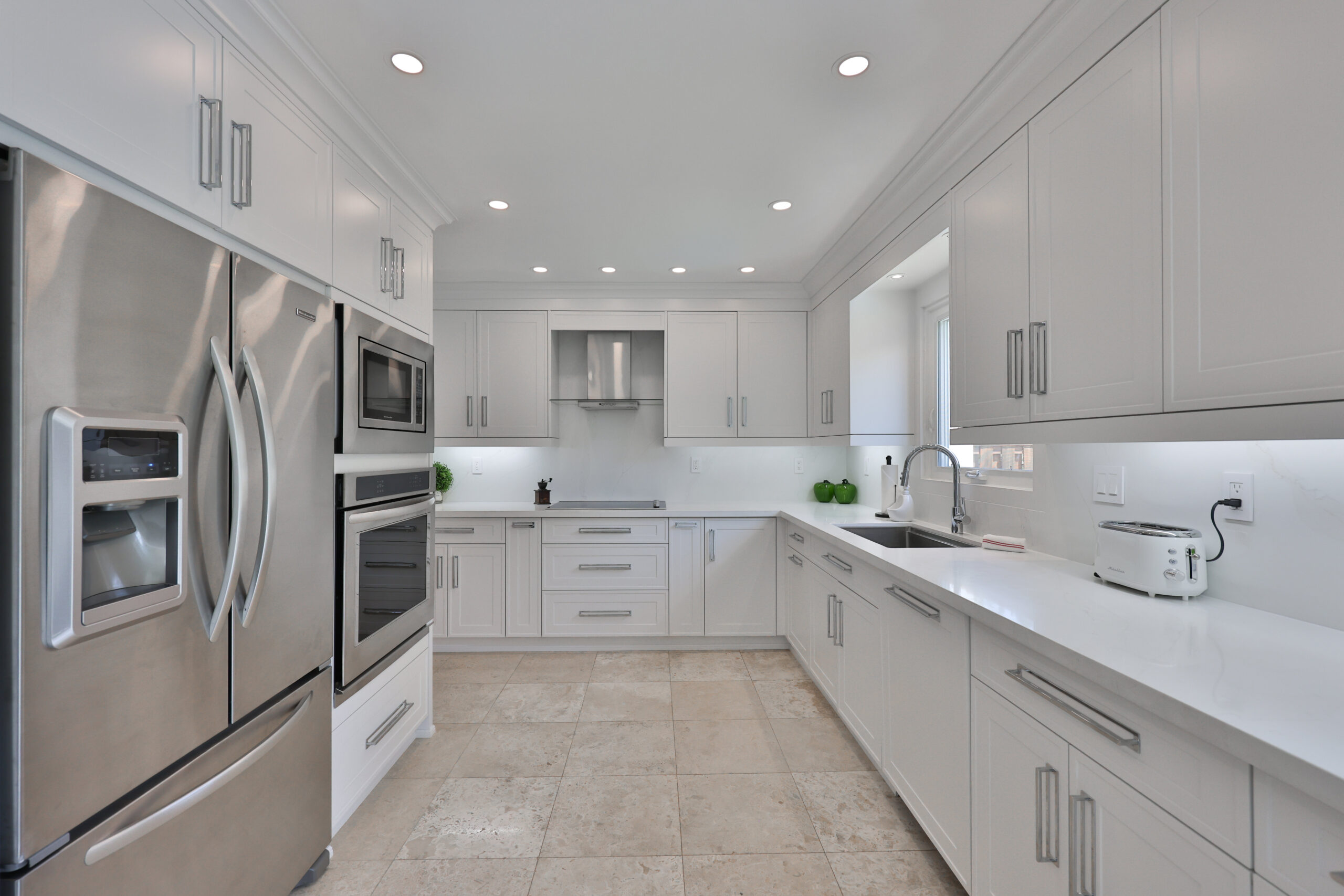 Modern kitchen with stainless steel appliances and white cabinetry