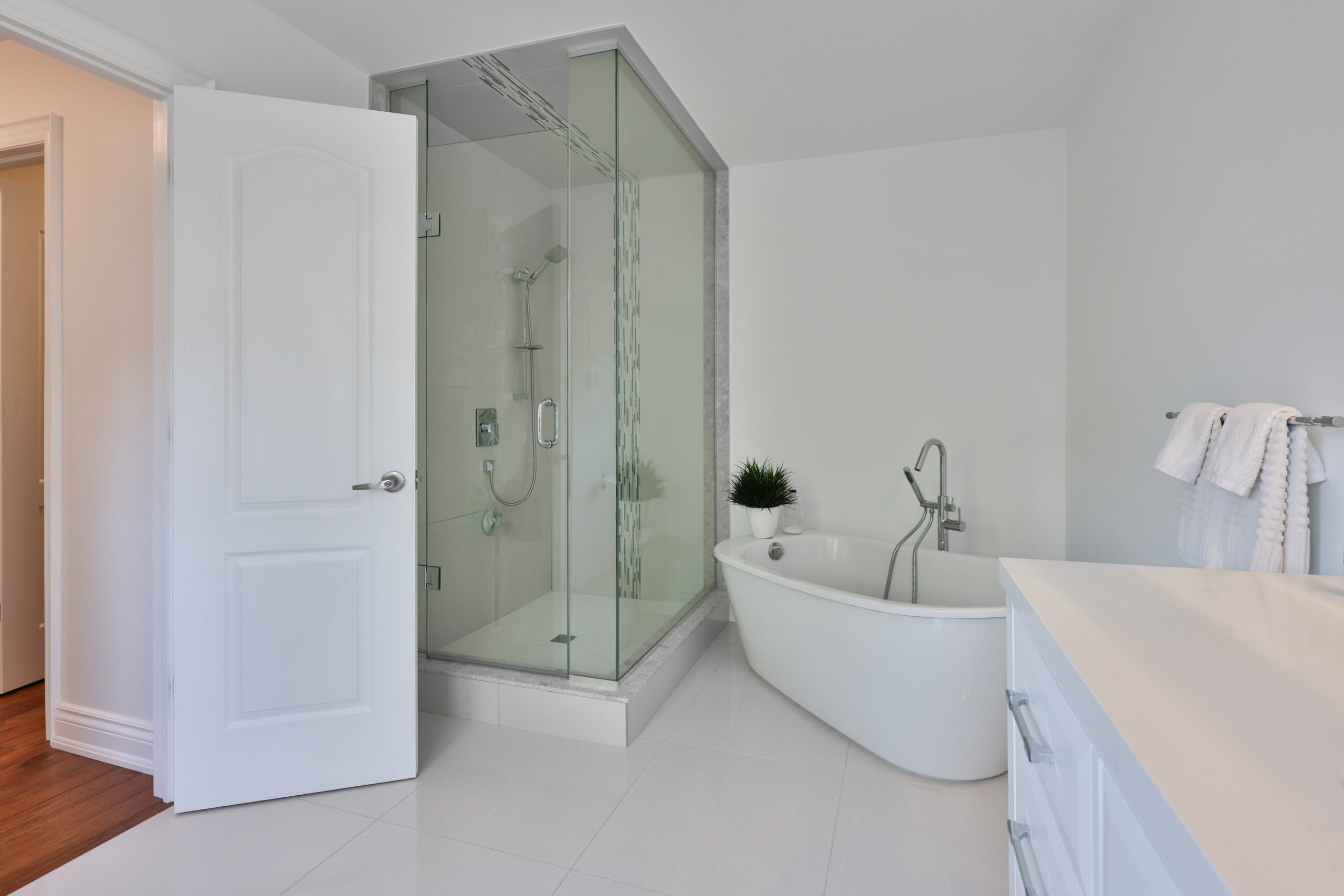 Modern bathroom featuring a glass shower and freestanding bathtub