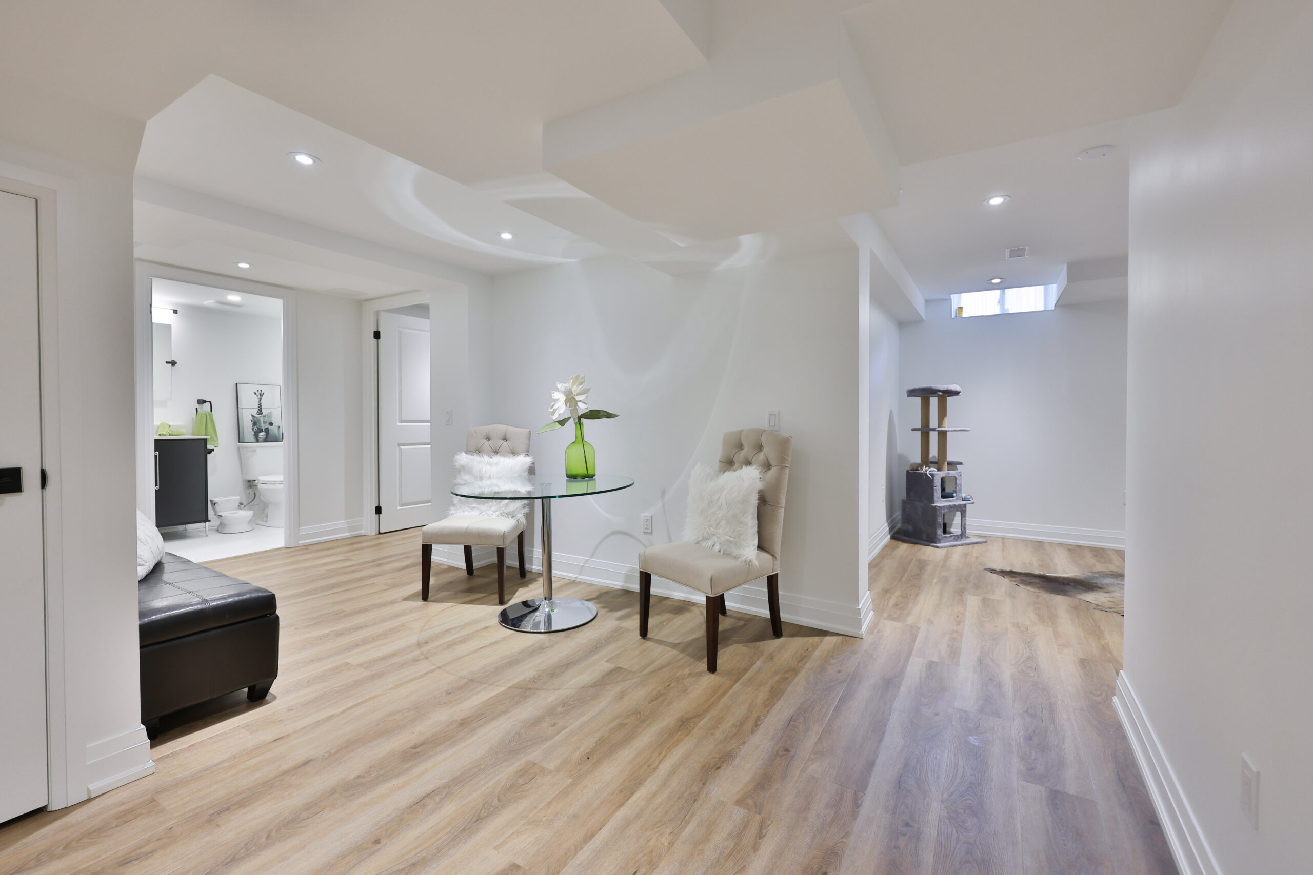 Modern basement interior with light wood flooring and stylish furniture