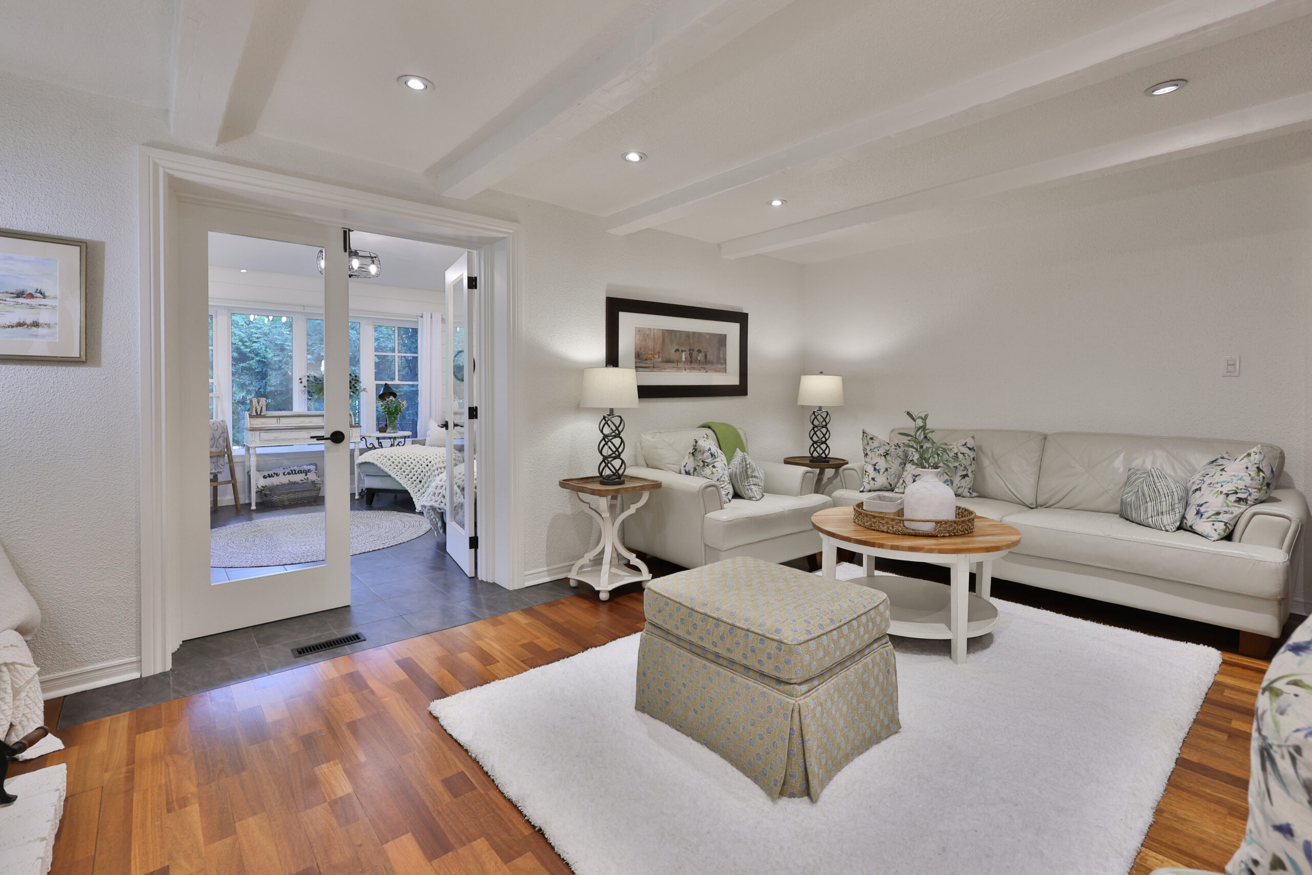 family room with double doors leading to 4 seasons room