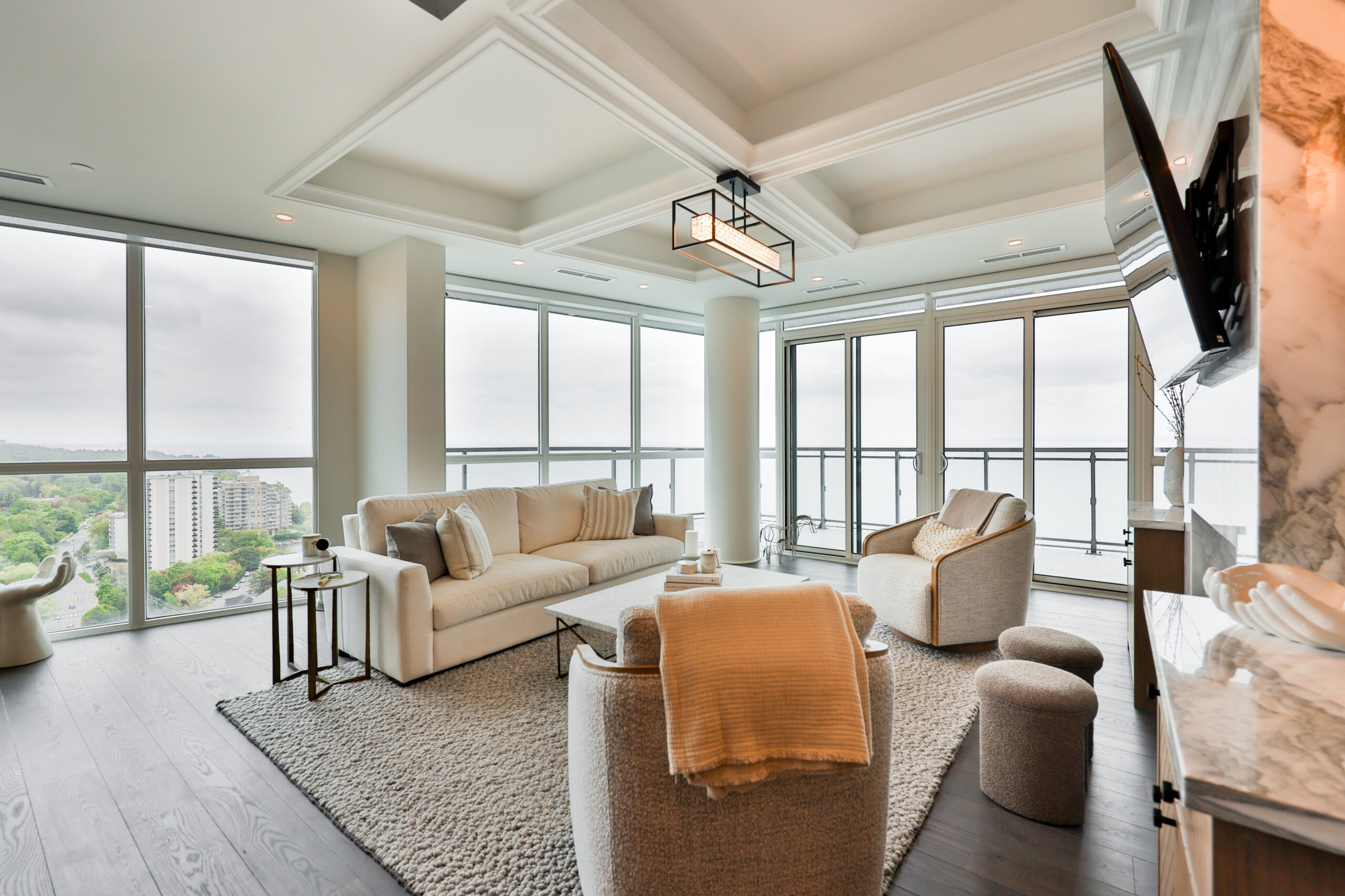 large family room surrounded by floor to ceiling windows