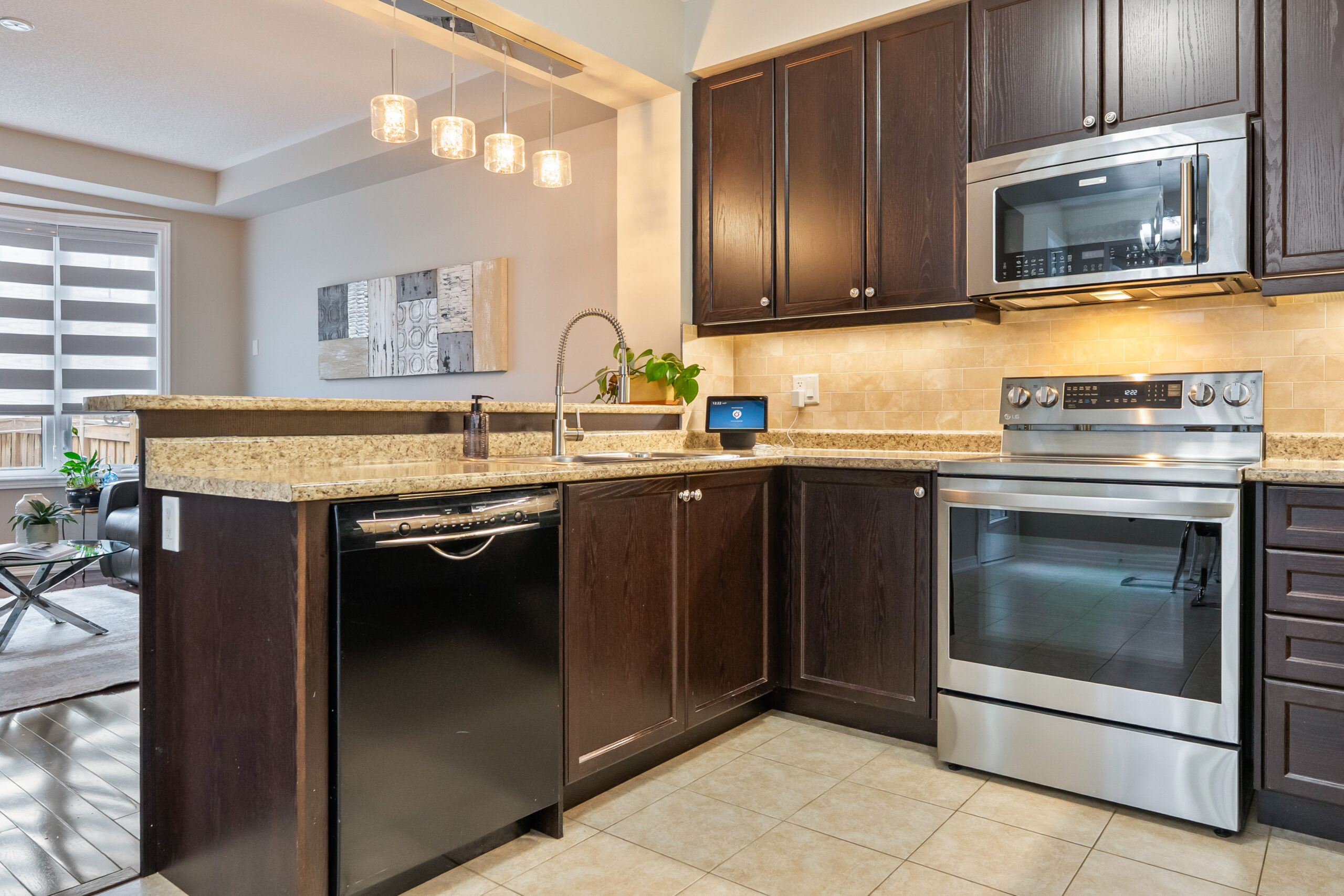 open kitchen with stainless steel microwave and oven. over looking breakfast area