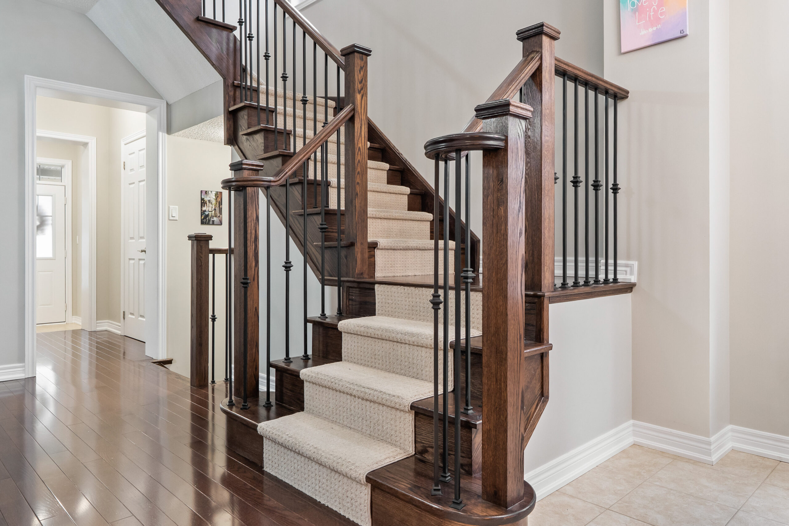 stairs with carpet runners leading to second floor
