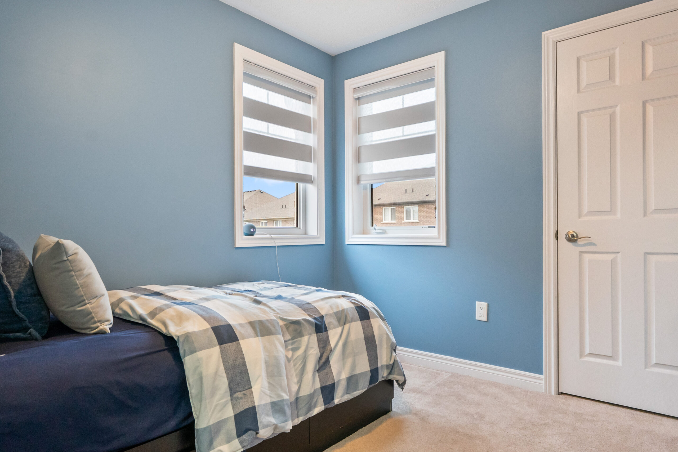 second bedroom with closet and double windows