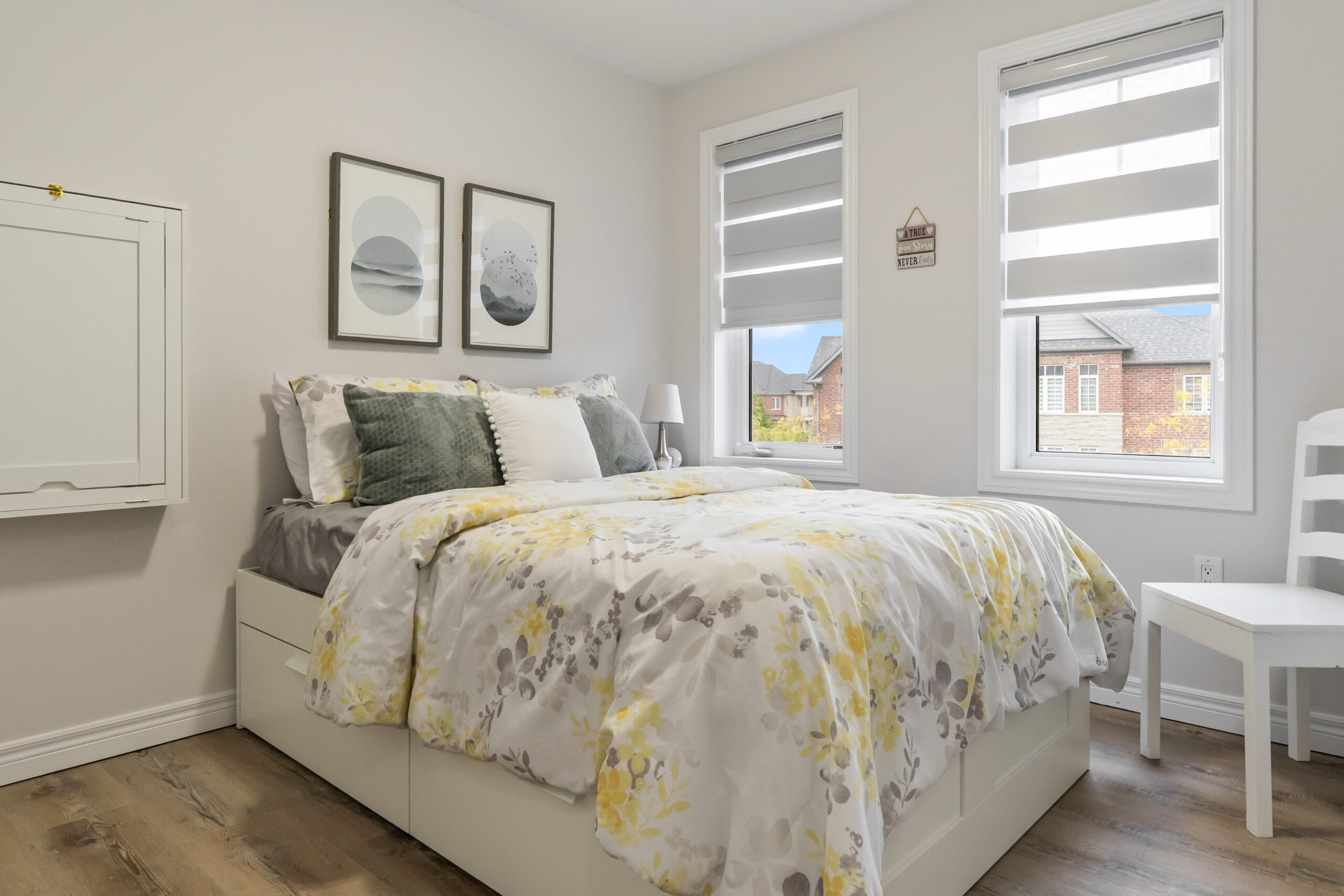 third bedroom with double windows and light brown flooring