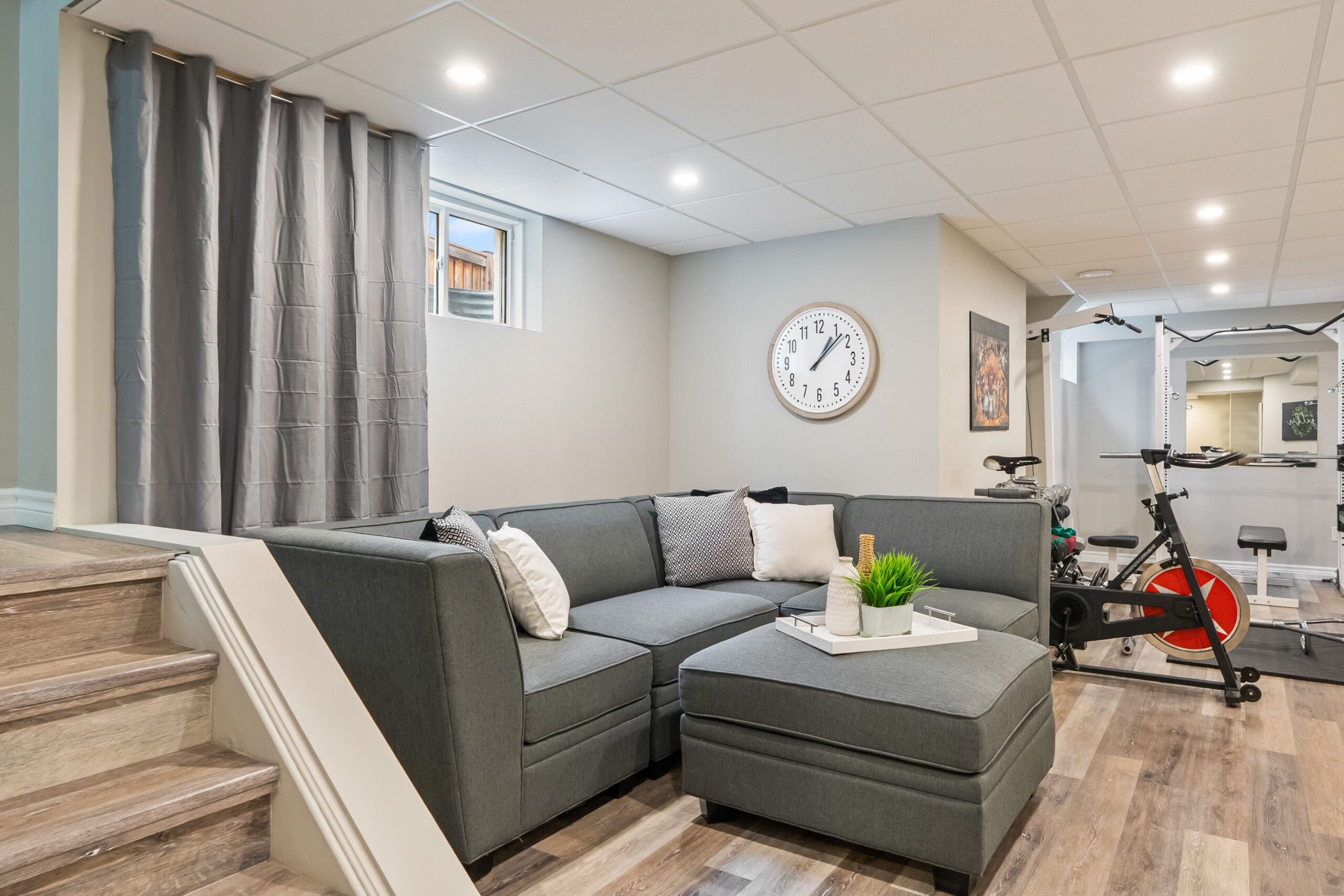 basement recreation room with hard wood flooring