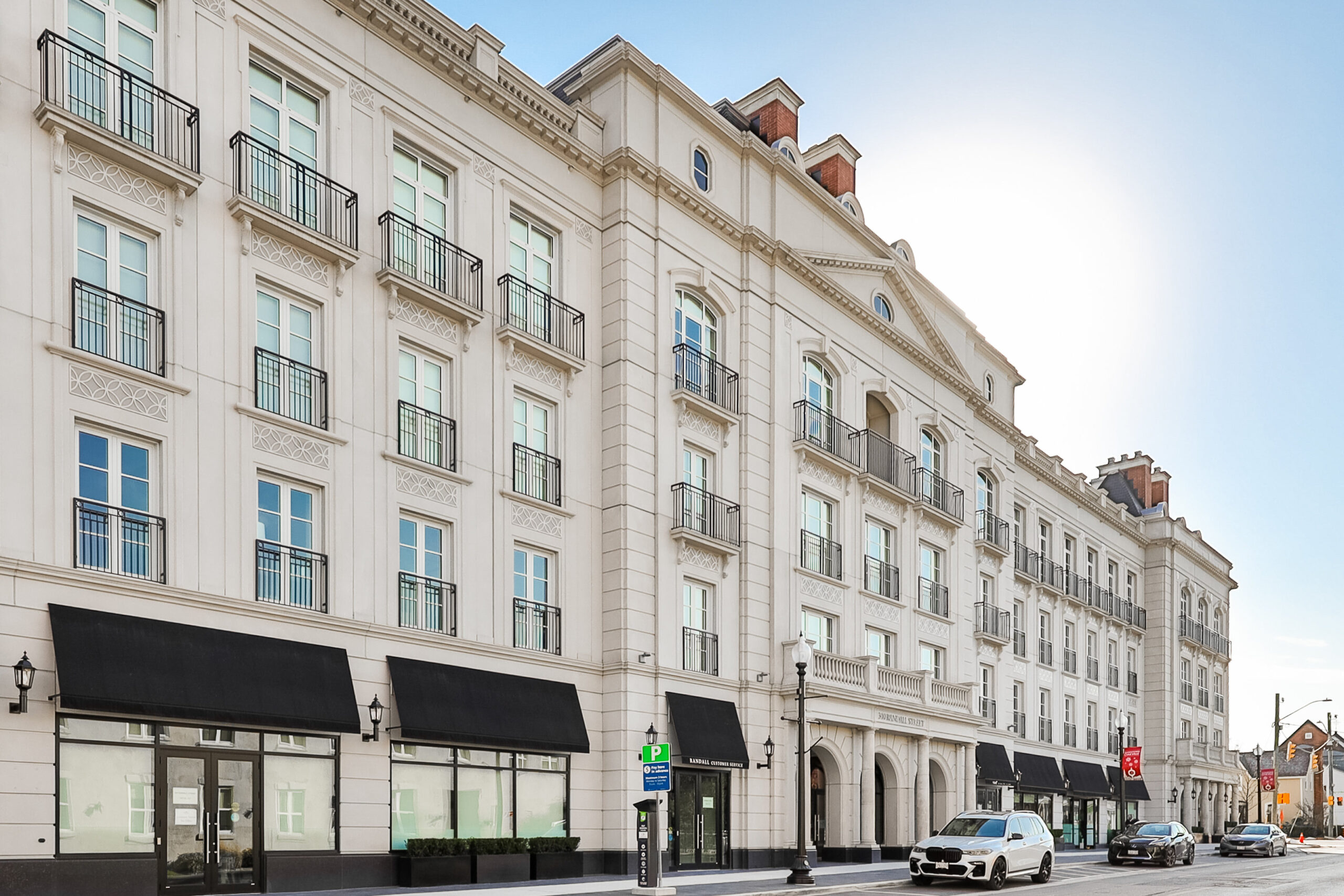 full photo of building showing scale and retail stores on ground floor
