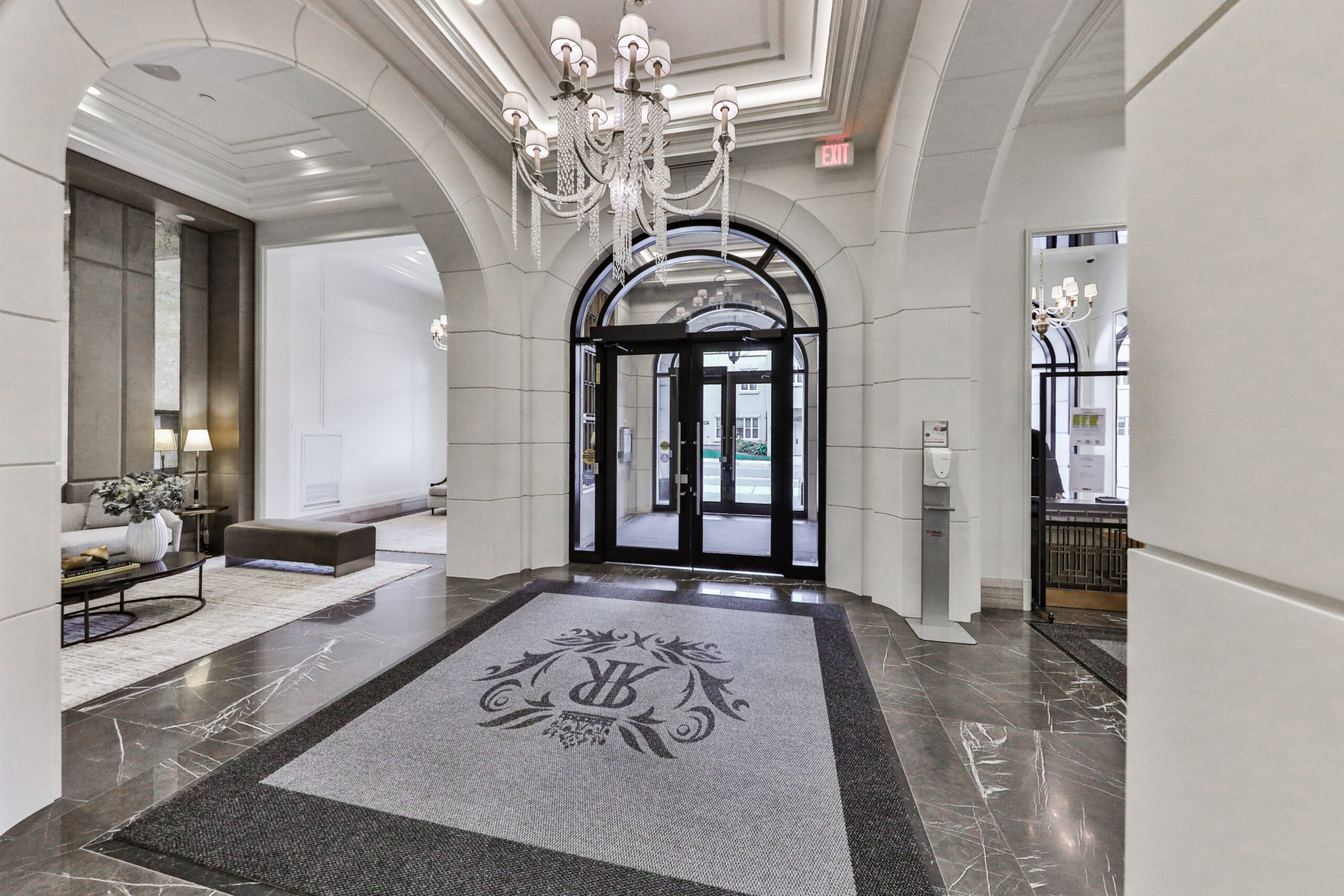 interior foyer with seating area and crystal chandeliers