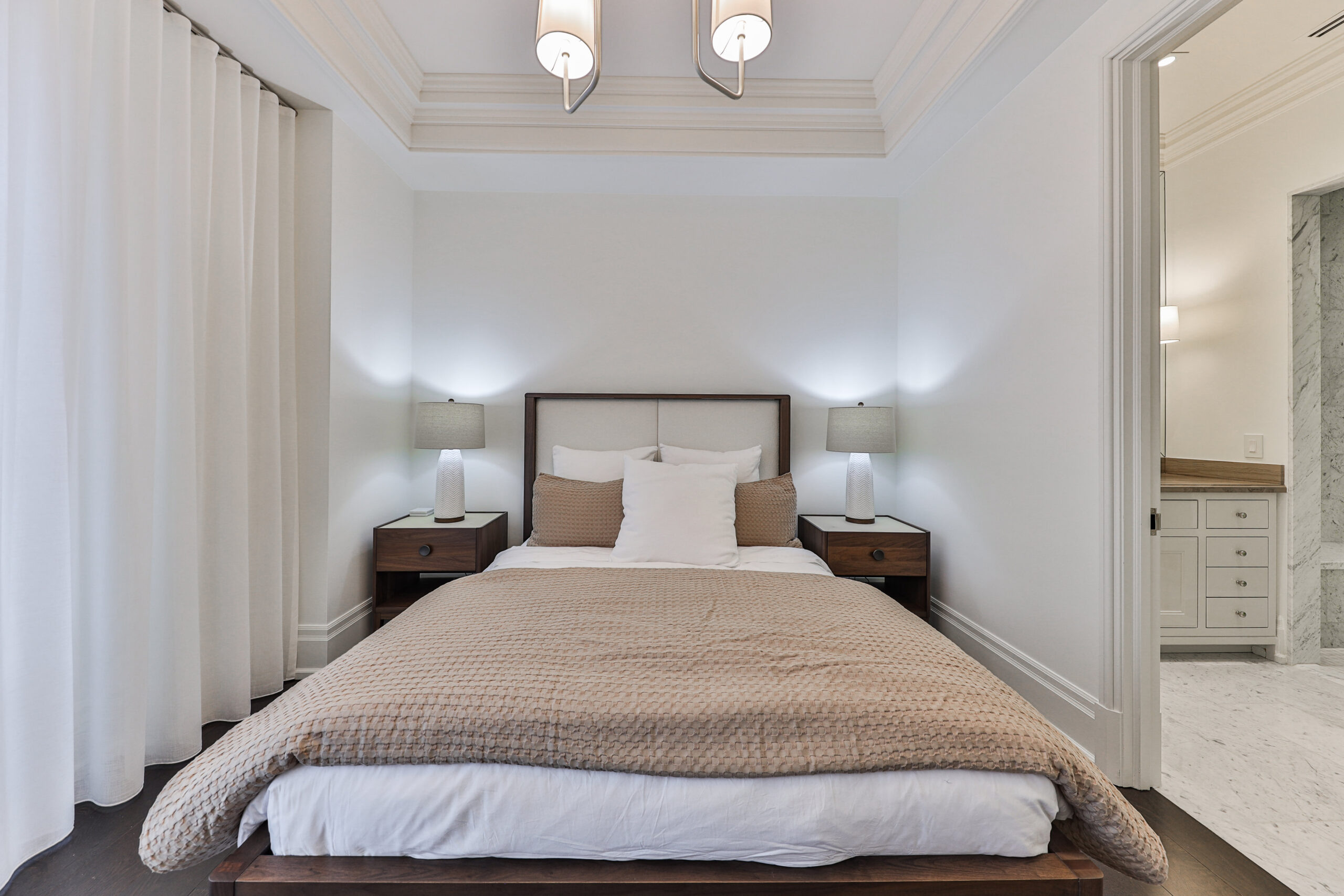 Cozy bedroom with a bed, bedside tables, and soft lighting