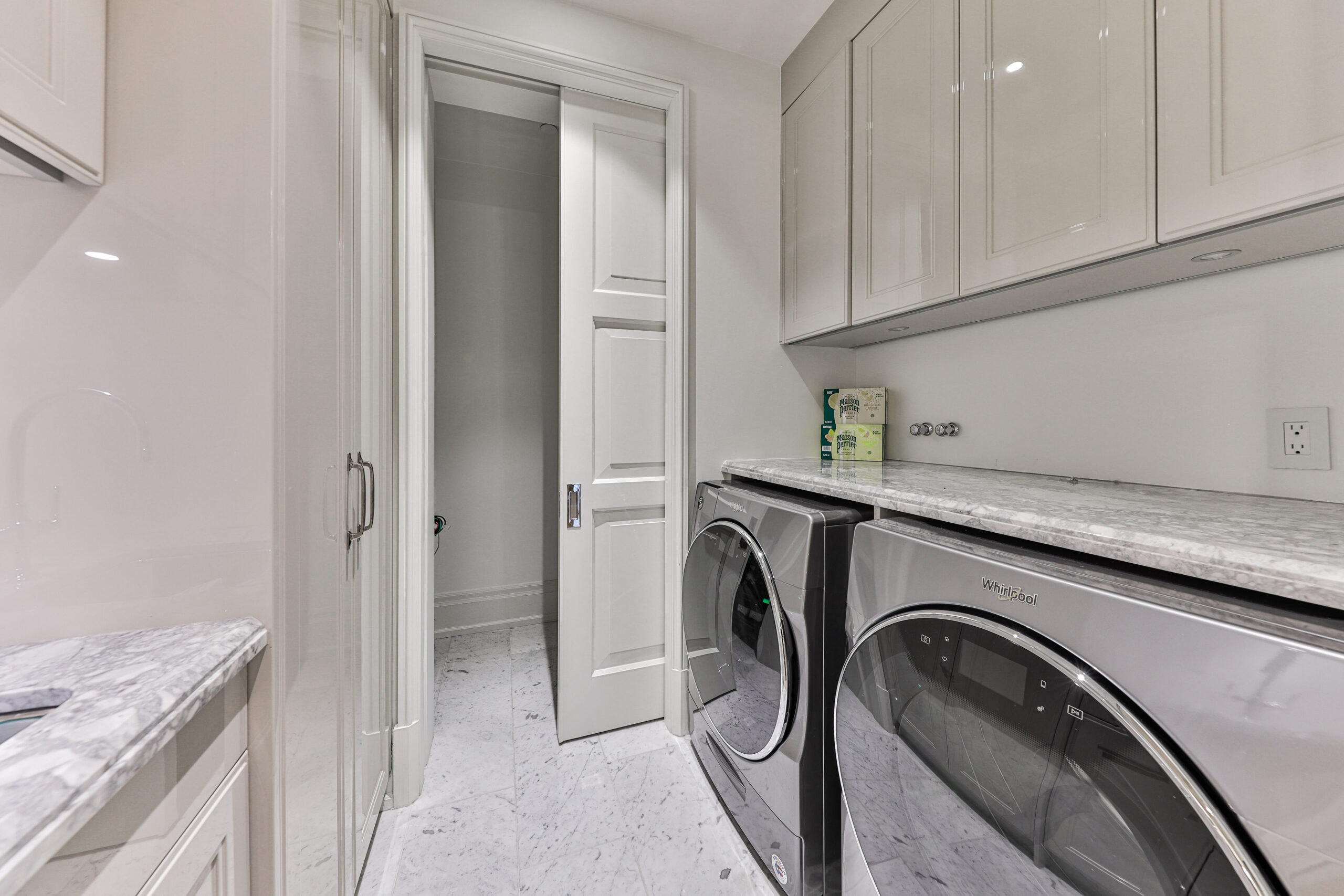 laundry room with counter space and storage