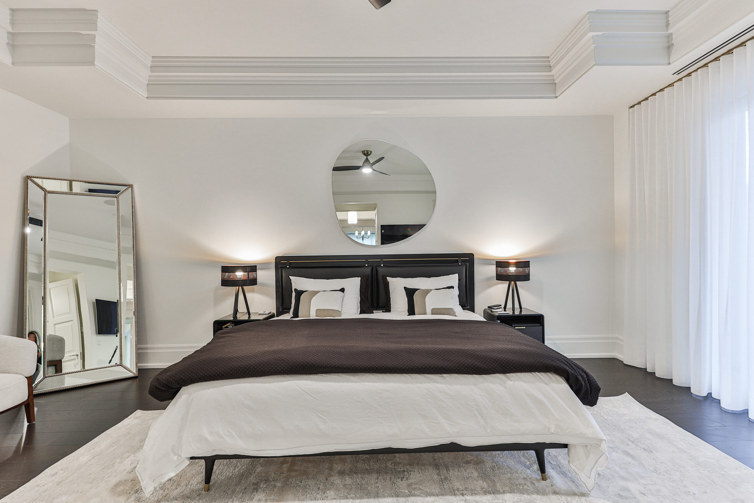 Spacious bedroom with a black and white color scheme and modern decor