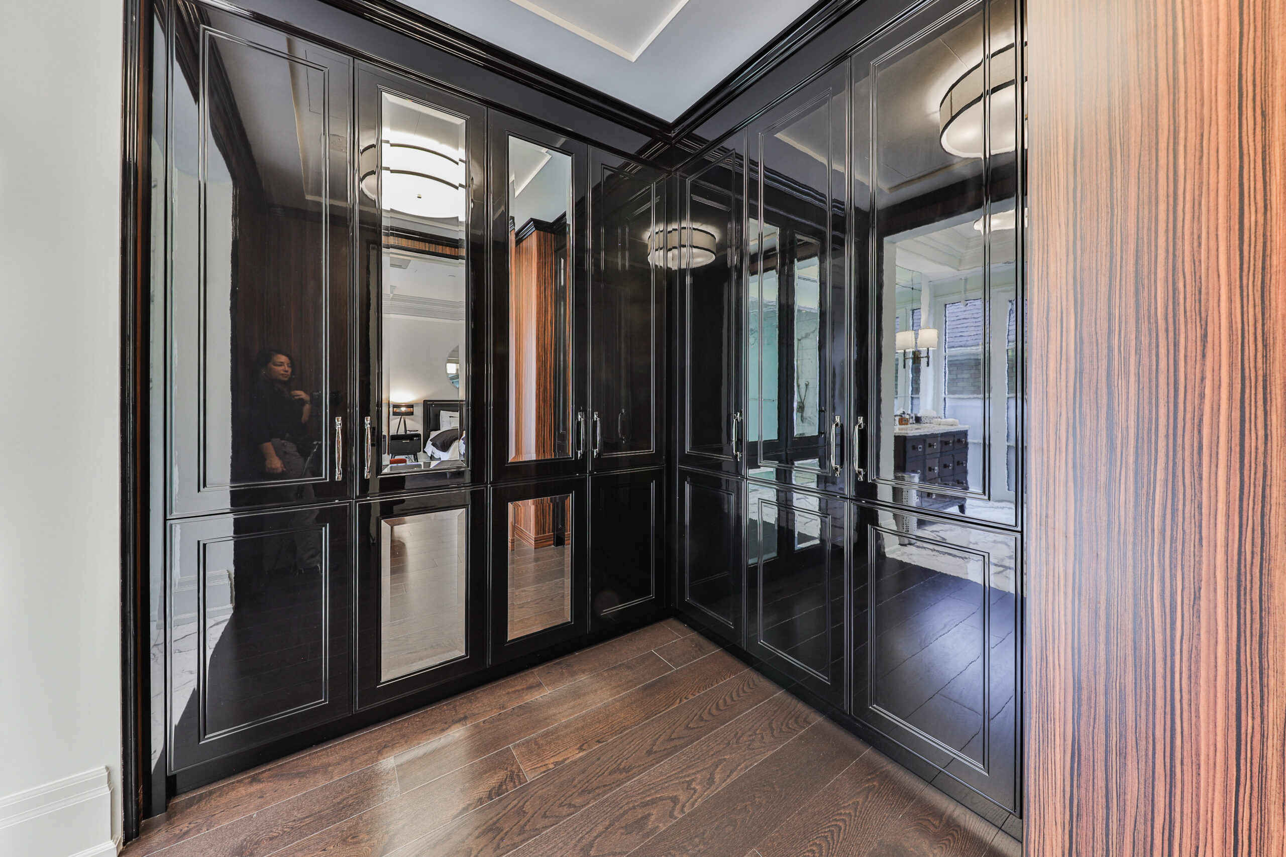 Modern hallway with dark cabinetry and stylish lighting fixtures