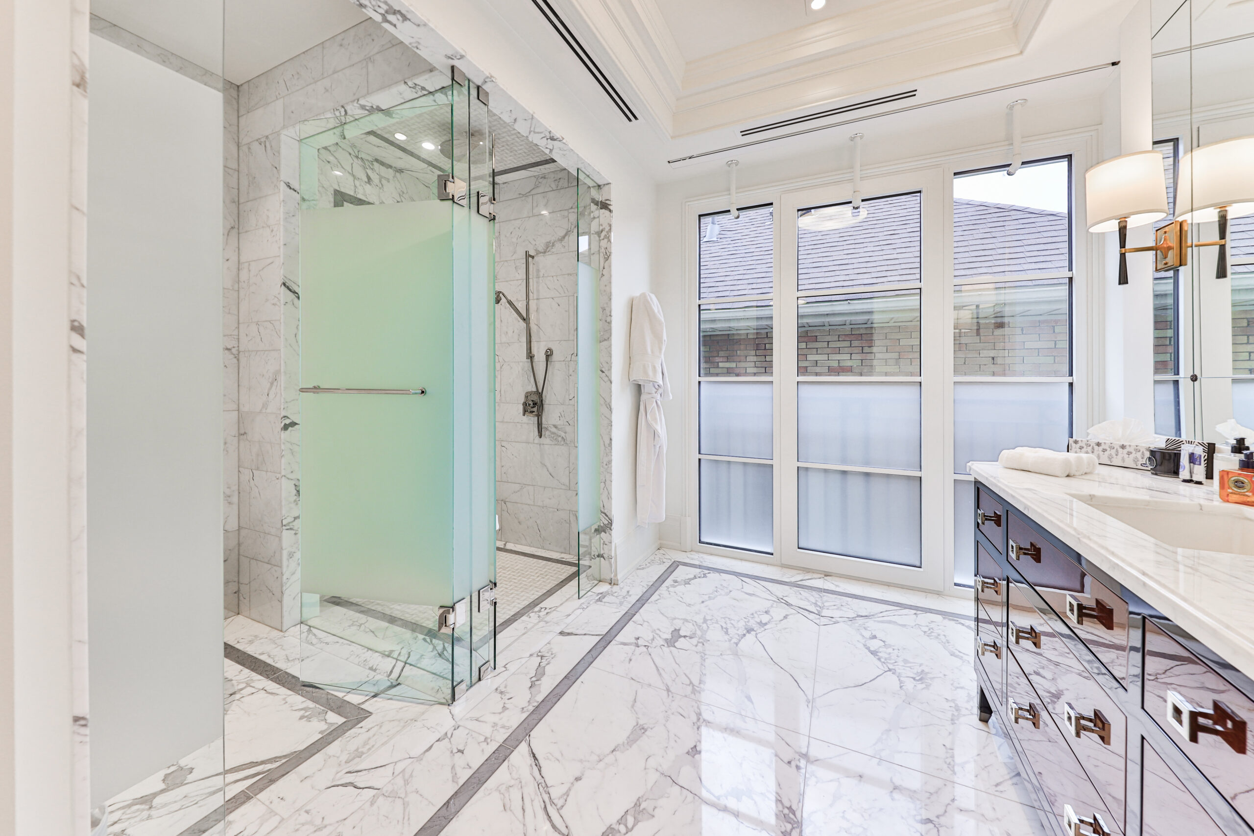 large principal ensuite with marble floors, double vanity, separate walk in shower and bathroom area