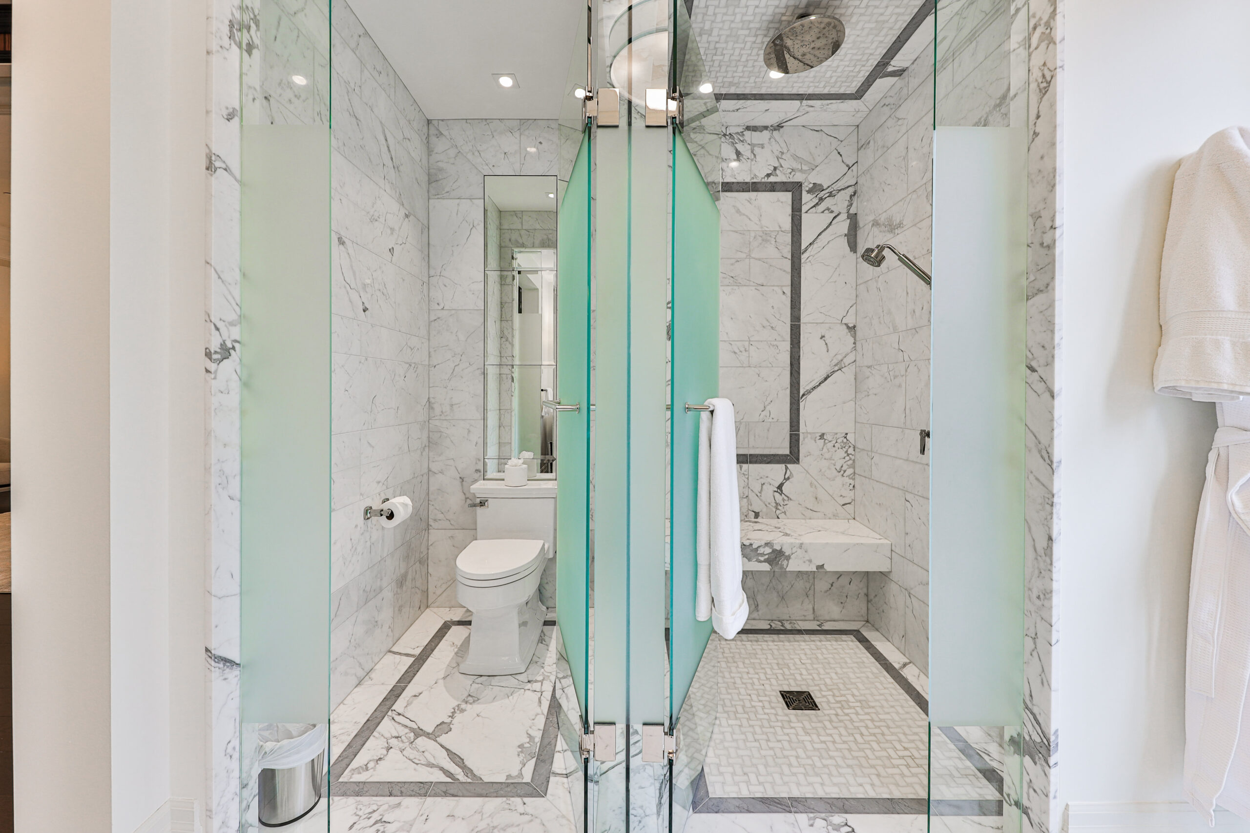 marble and glass enclosed shower, bathroom area