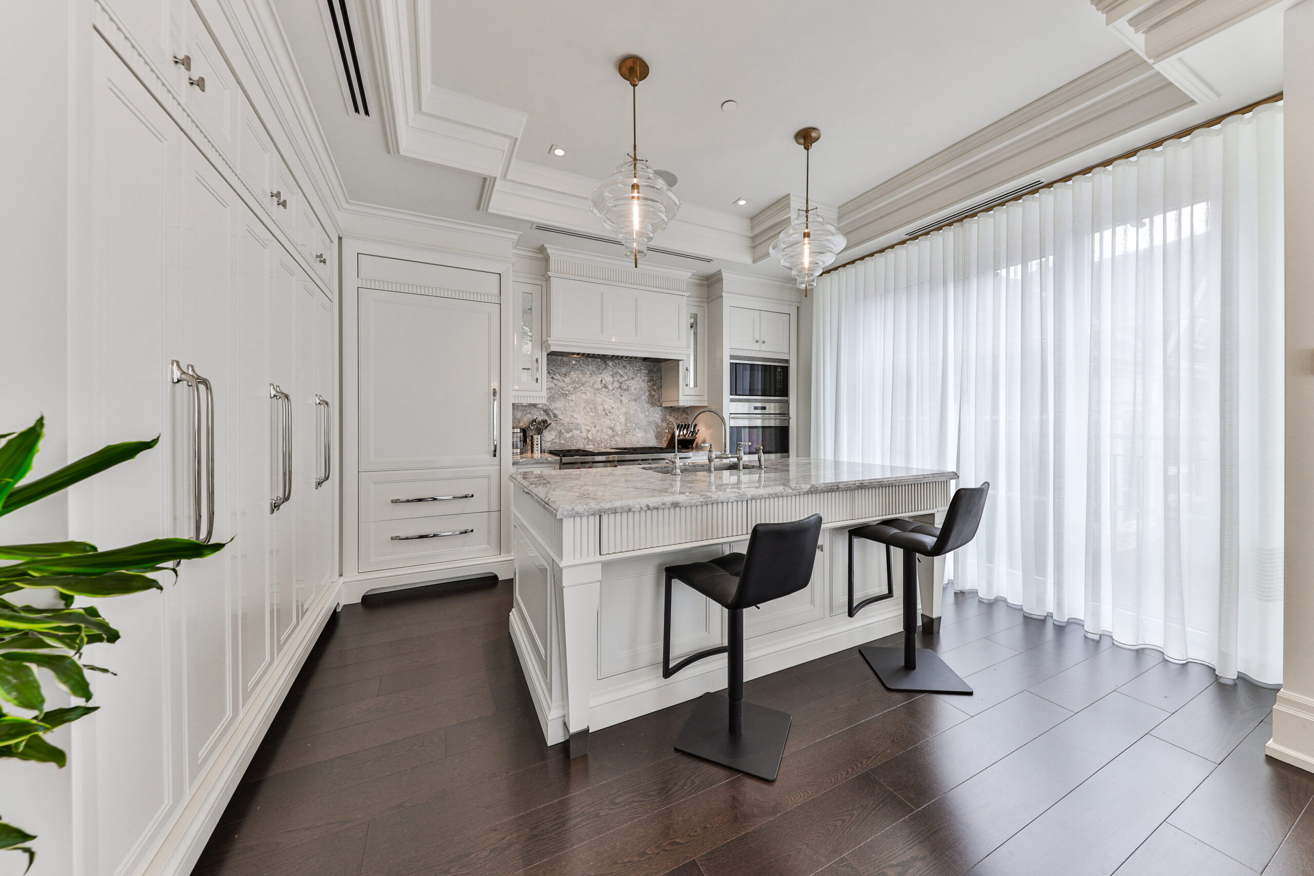 floor to ceiling custom cabinetry, large island, marble counter tops