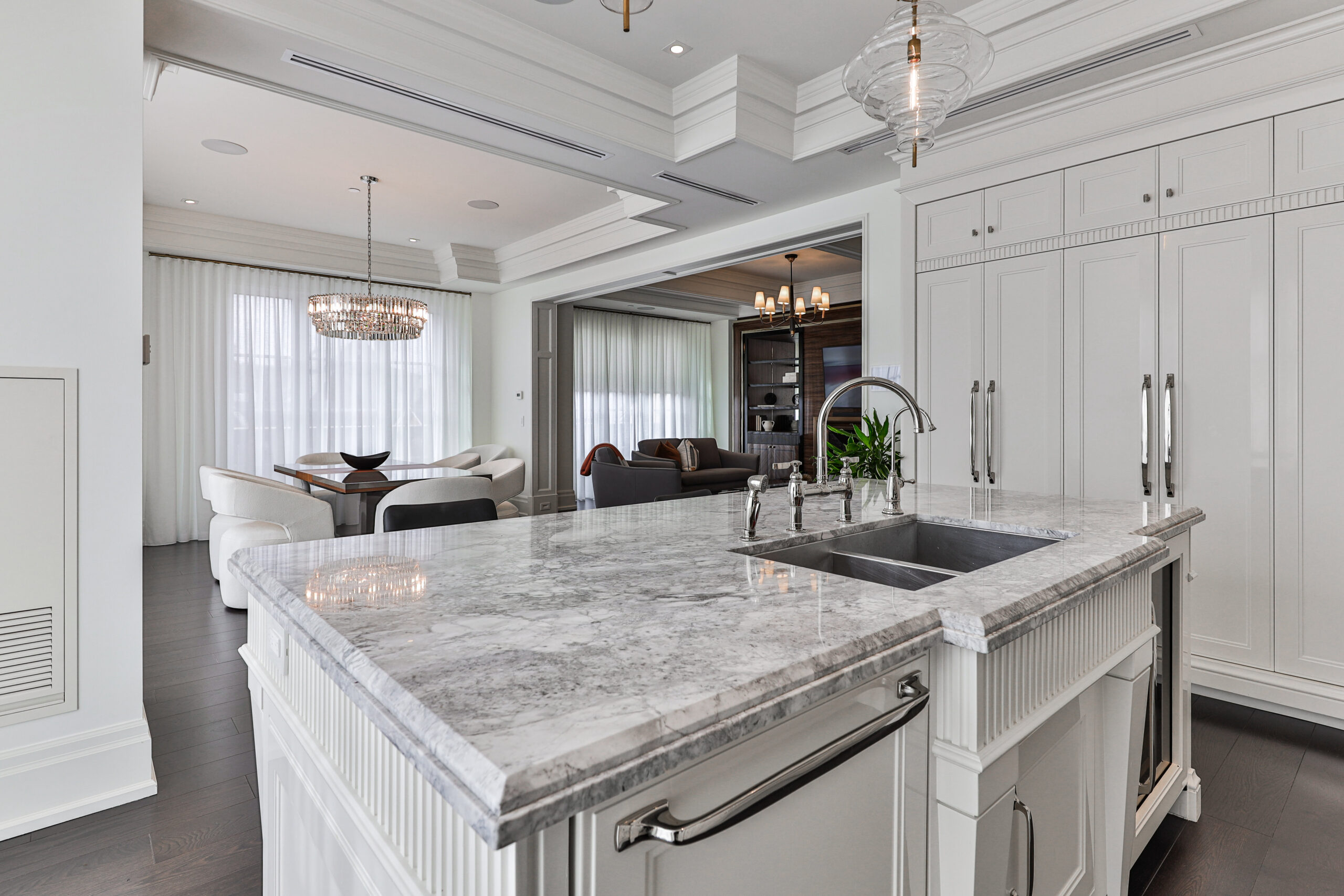 Modern kitchen with a marble island and white cabinetry